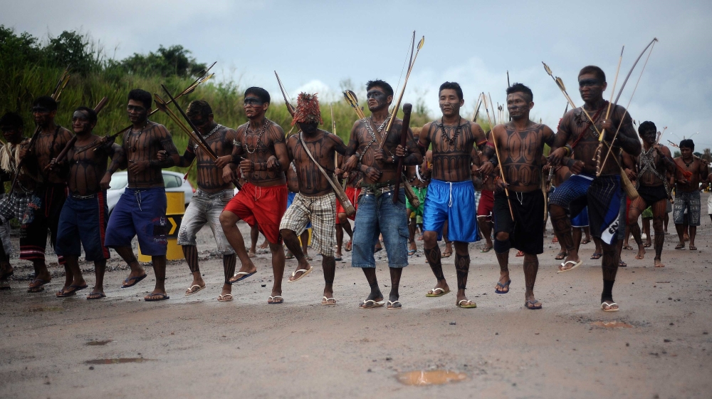 Amazon Indigenous men from different tribes holding a march to demonstrate their unity before delivering their response to a government proposal to end their occupation of the Belo Monte hydroelectric dam construction site, in Vitoria do Xingu, near Altamira in Para State