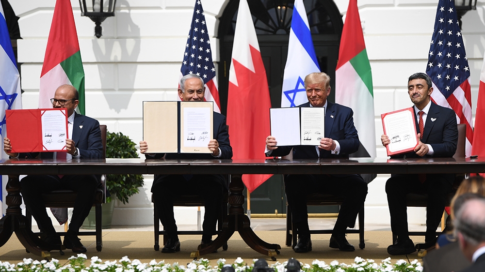 (L-R)Bahrain Foreign Minister Abdullatif al-Zayani, Israeli Prime Minister Benjamin Netanyahu, US President Donald Trump, and UAE Foreign Minister Abdullah bin Zayed Al-Nahyan hold up documents as the