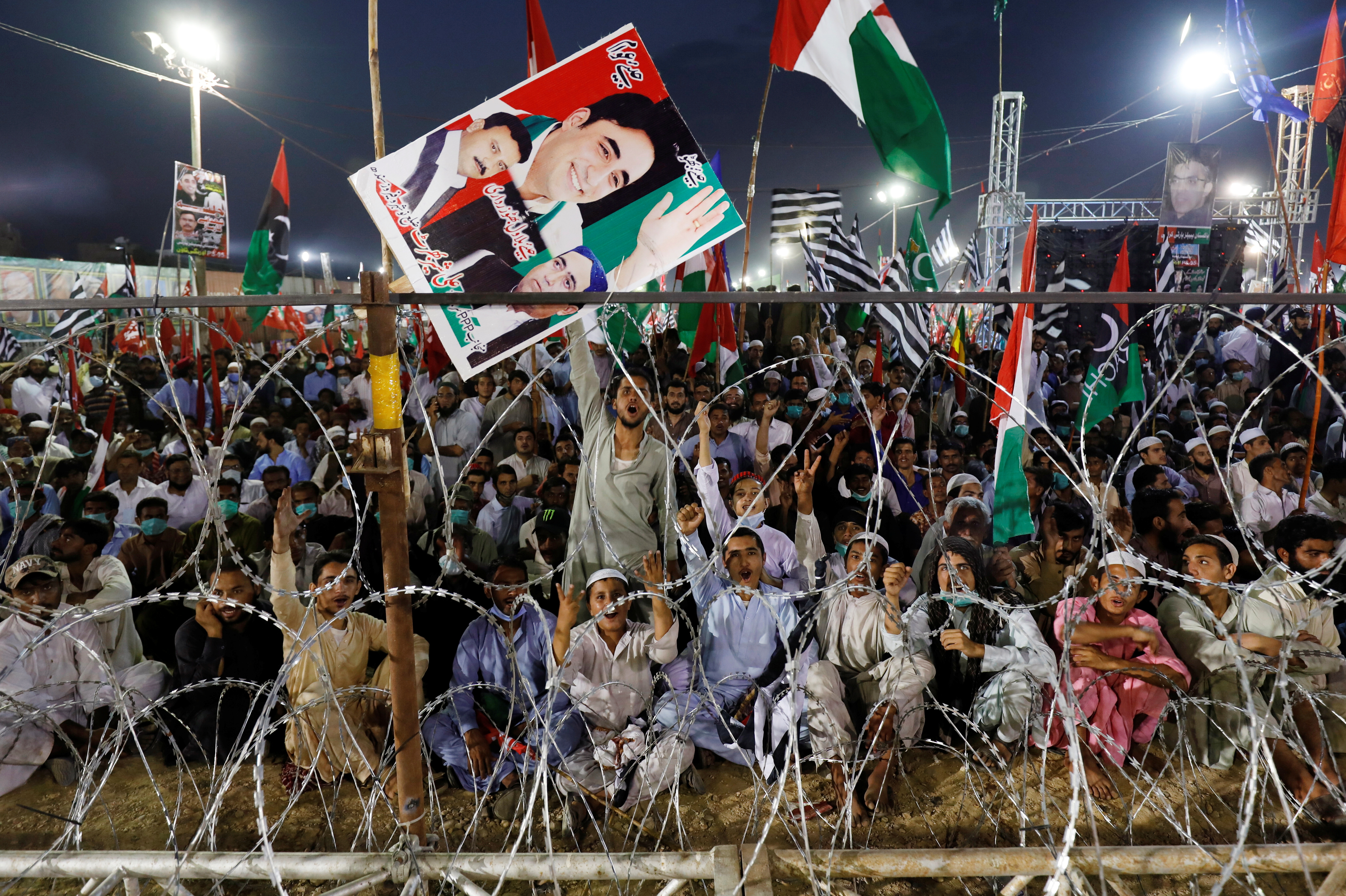 Supporters of the Pakistan Democratic Movement (PDM), an alliance of political opposition parties, listen to their leaders during an anti-government rally in Karachi