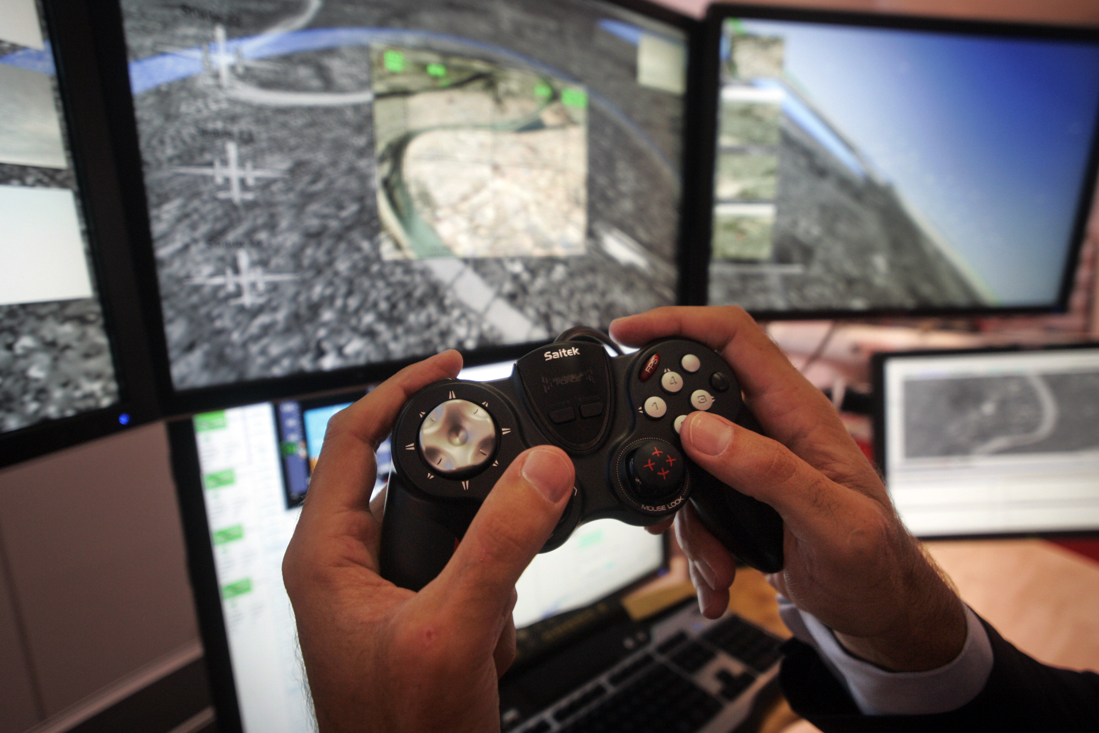 A man uses a PlayStation-style console to manoeuvre the ‘aircraft’, as he demonstrates a control system for unmanned drones