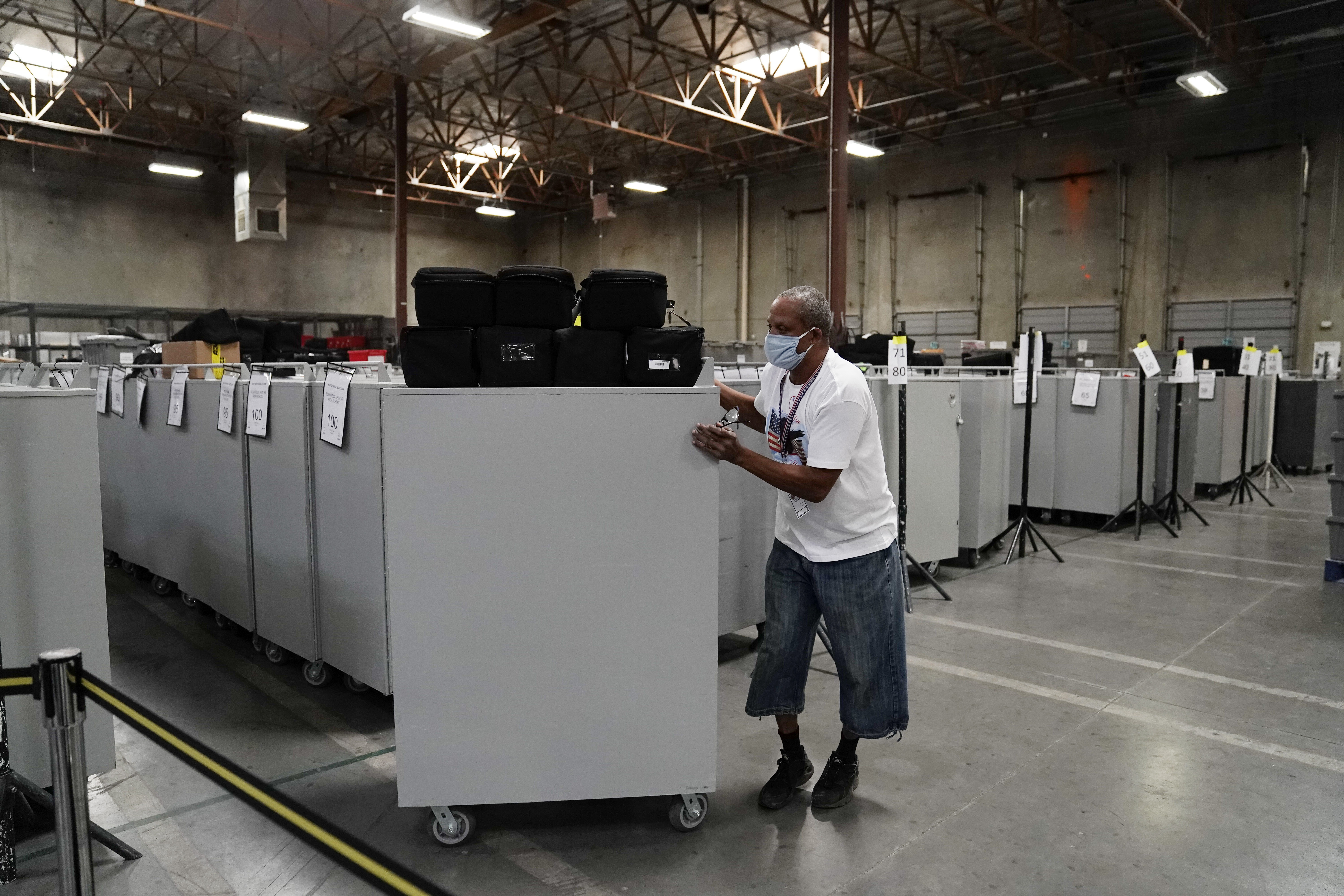 An election warehouse worker moves polling place equipment at the Clark County Election Department in North Las Vegas, Nevada