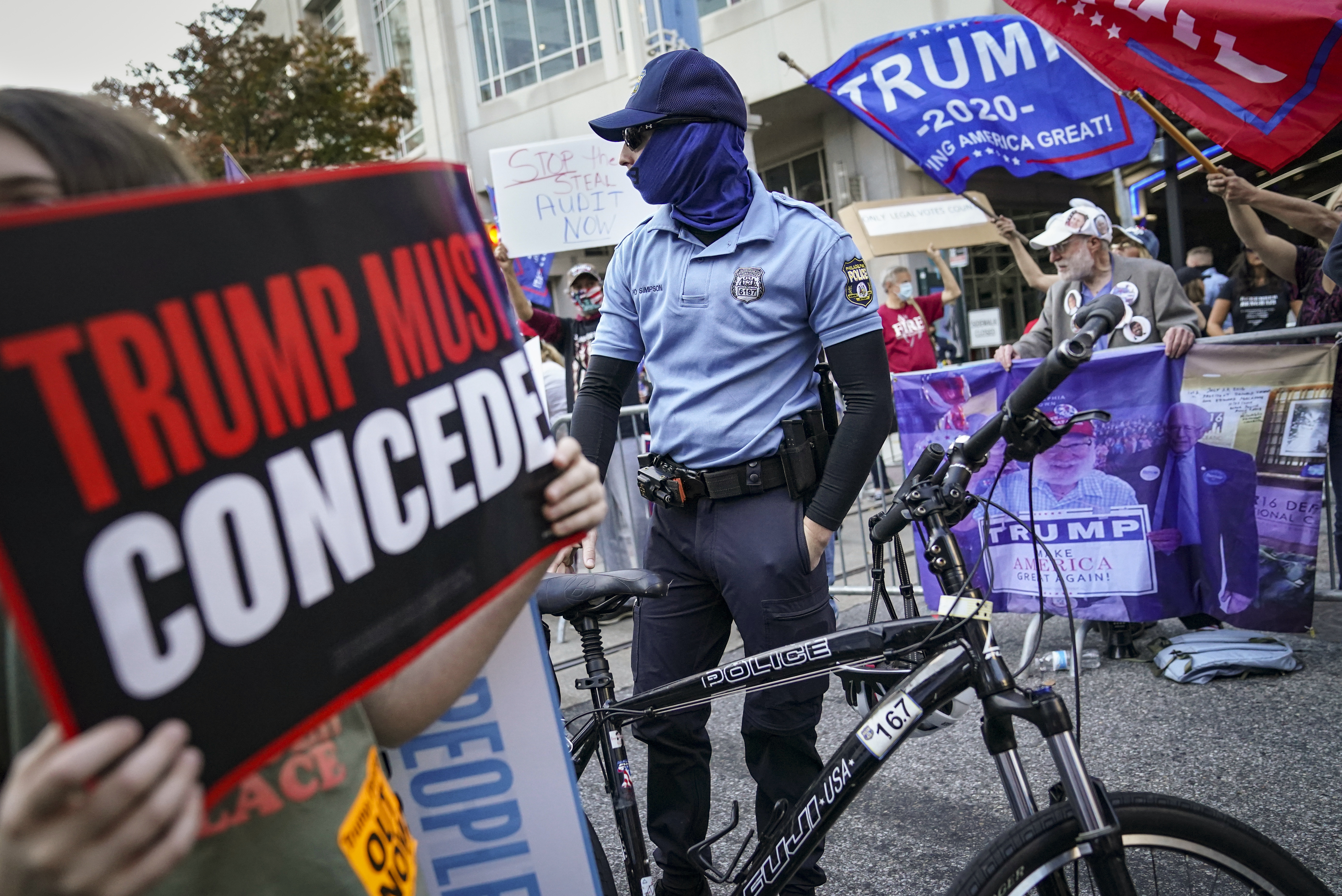 Police separate President Donald Trump supporters and pro-vote counting demonstrators outside the Philadelphia Convention Center where votes were still being counted on Friday