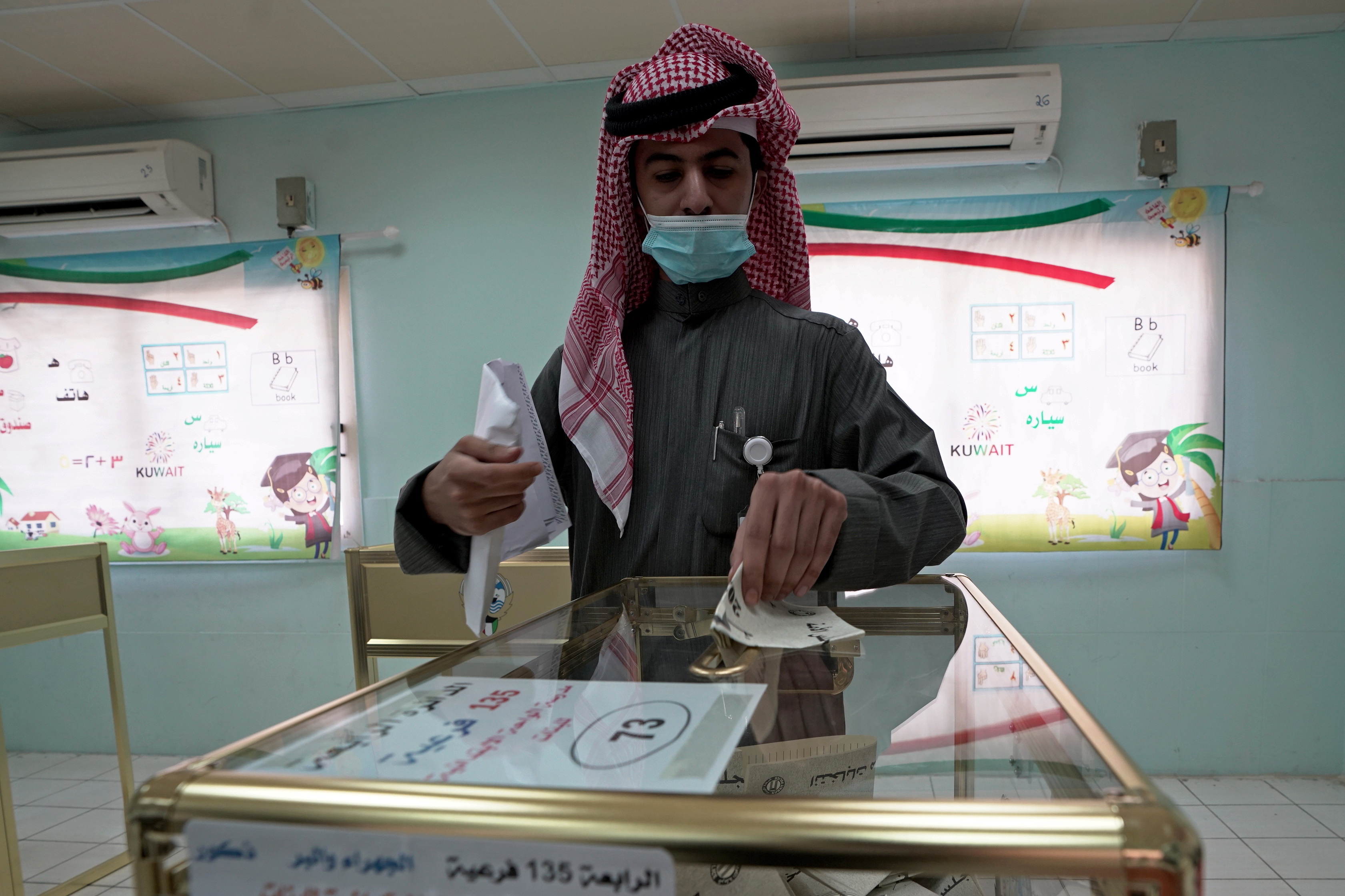 A Kuwaiti casts his vote during parliamentary elections in Jahra City, Kuwait