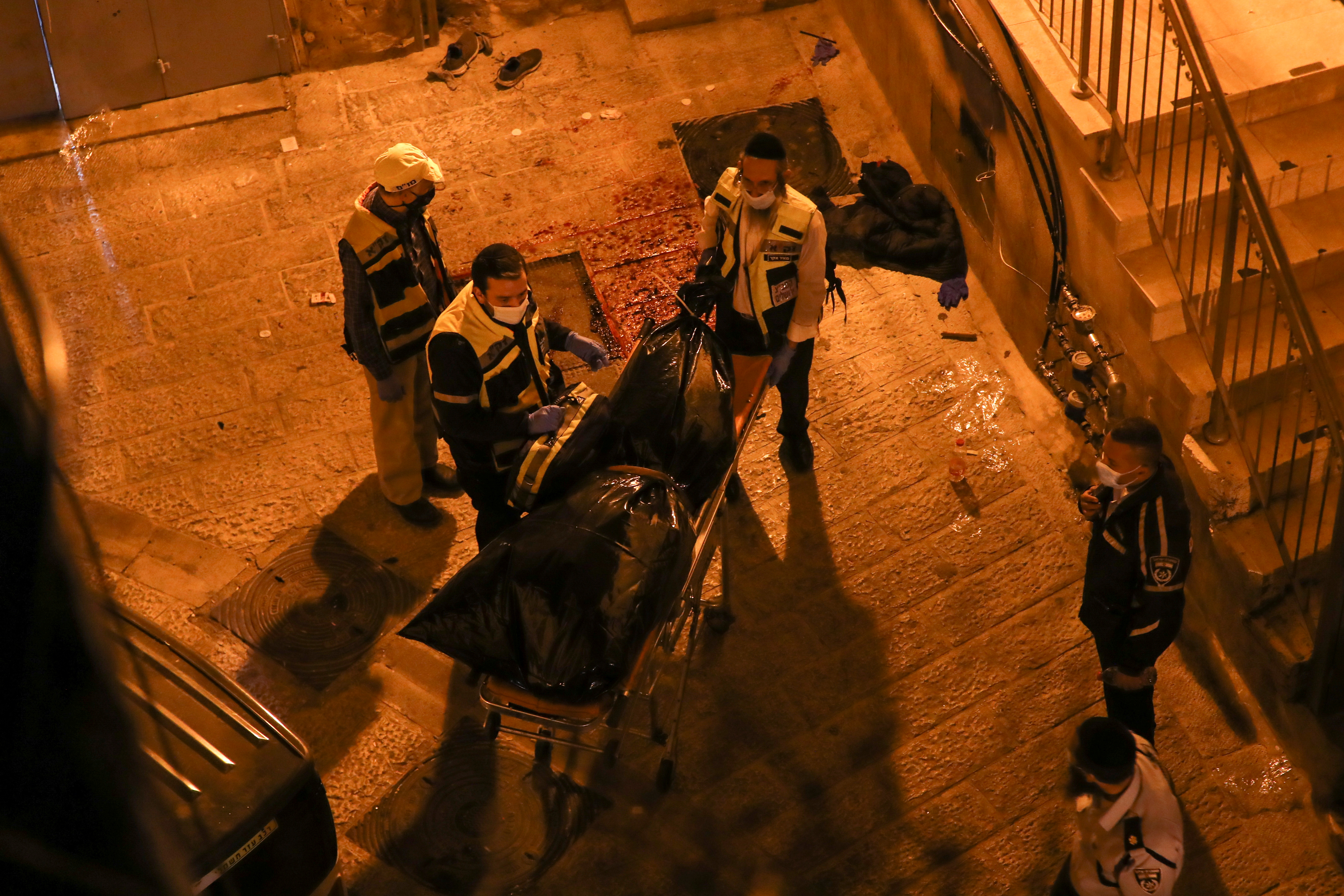 Israeli voluntary community emergency response team members pick up Kameel’s body after a shooting incident in occupied East Jerusalem’s Old City