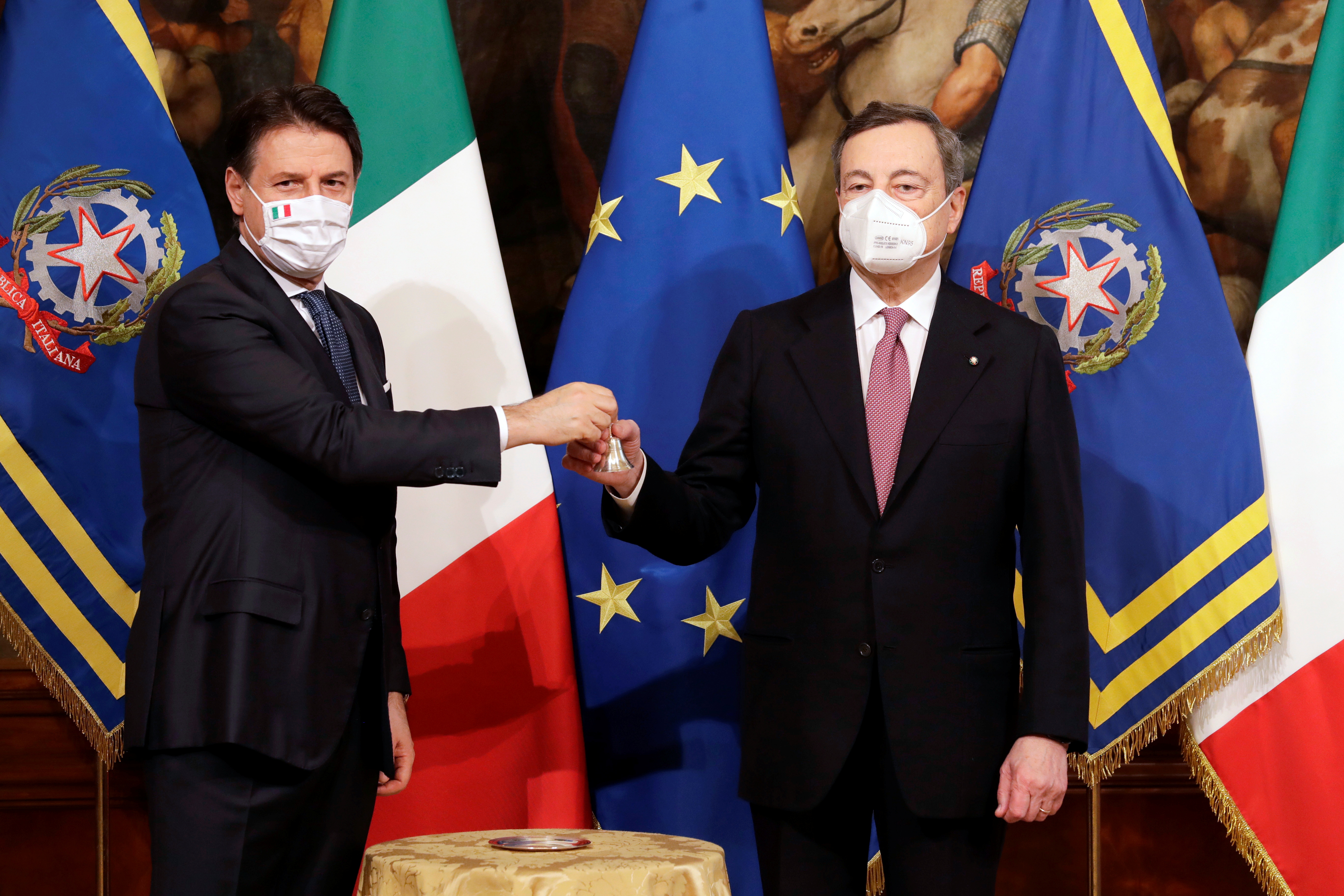 Outgoing Prime Minister Giuseppe Conte hands over the cabinet minister bell to Mario Draghi, during the handover ceremony at Chigi Palace Premier’s office, in Rome, Italy February 13, 2021