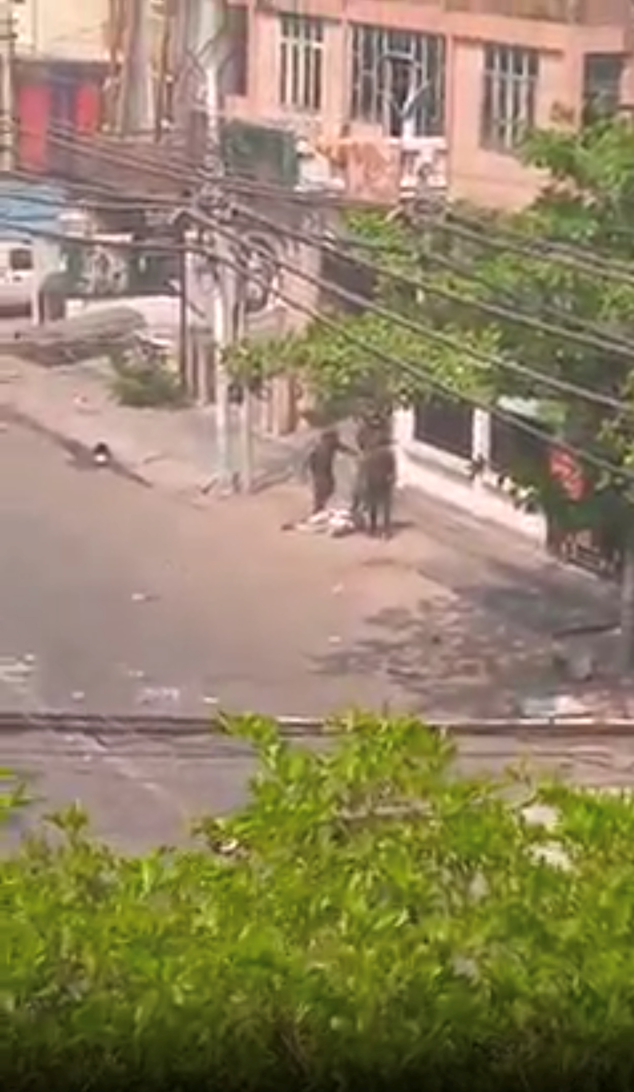 Security force officers kick a protester in Mandalay on March in a still image from a video obtained from social media