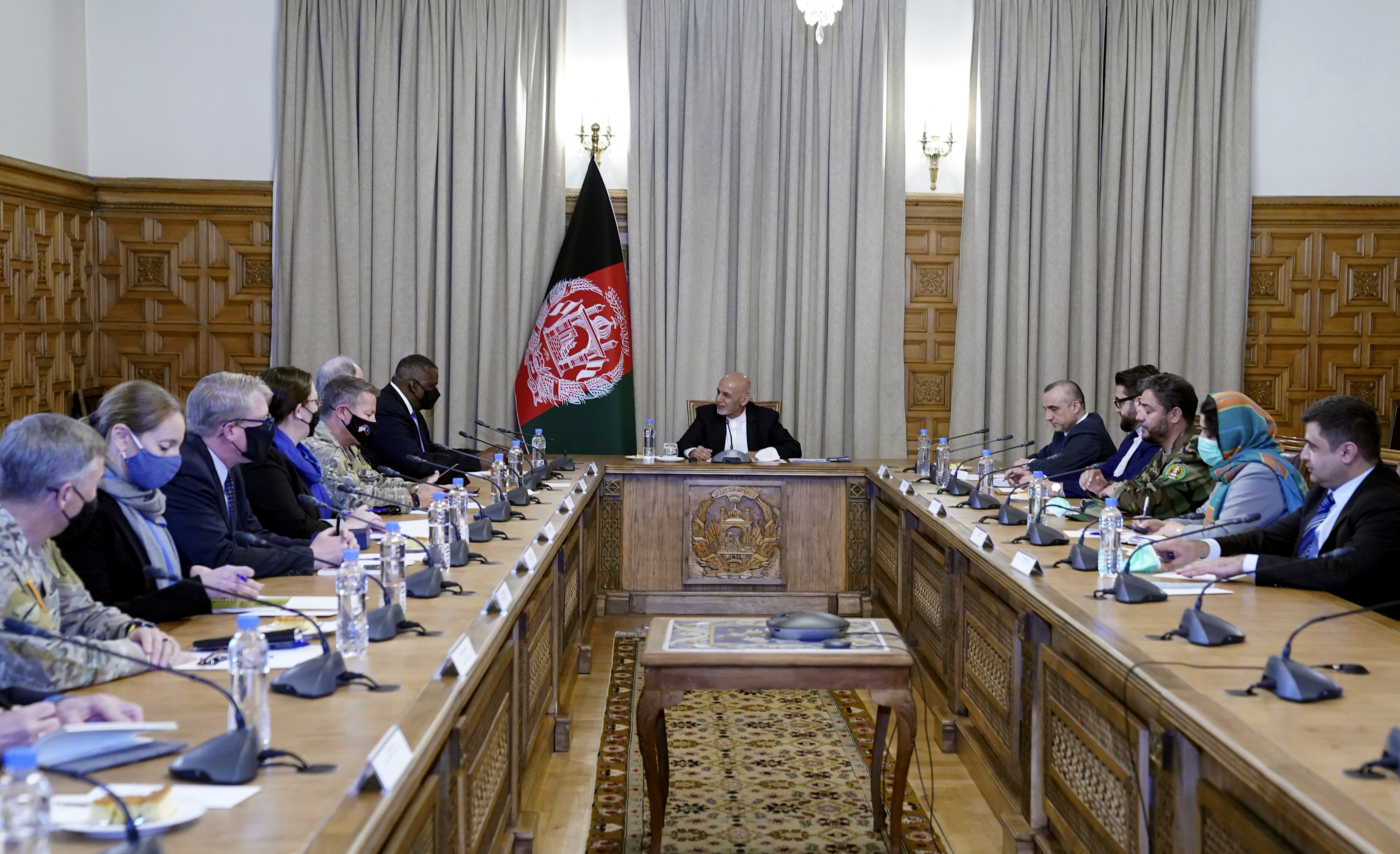 Afghan President Ashraf Ghani, centre, meets with US defence secretary Lloyd Austin, centre left, and their delegations, at the presidential palace in Kabul, Afghanistan [Presidential Palace via AP]