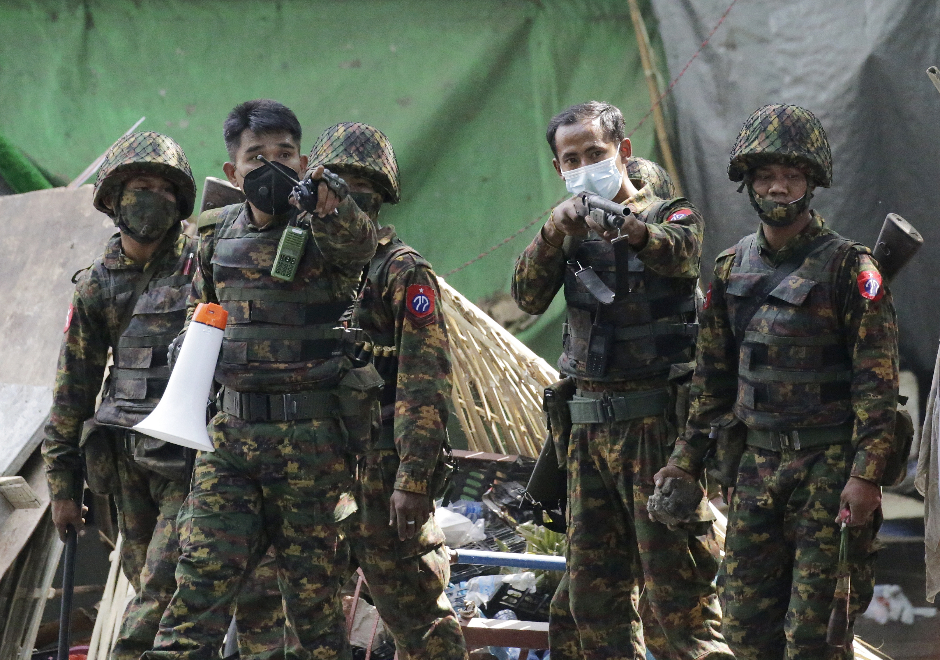 Soldiers advance to break up a crowd of protesters in Yangon on March 3. Australia said it was suspending a training programme with the Myanmar military over the increasing violence and rising death toll