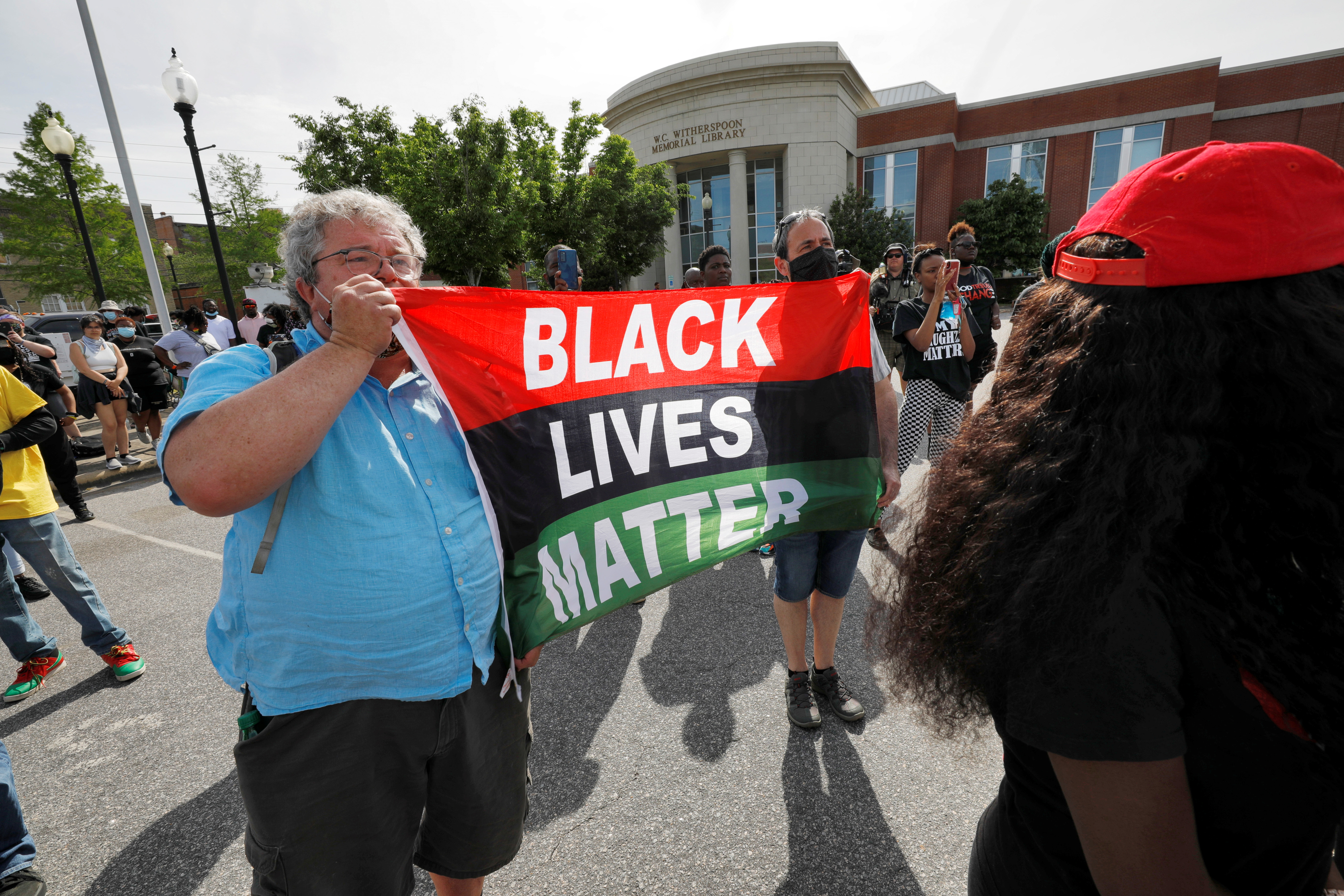 Author and historian Tim Tyson displays a Black Lives Matter flag at a protest 11 days after the killing of Andrew Brown Jr in Elizabeth City, North Carolina on May 2, 2021