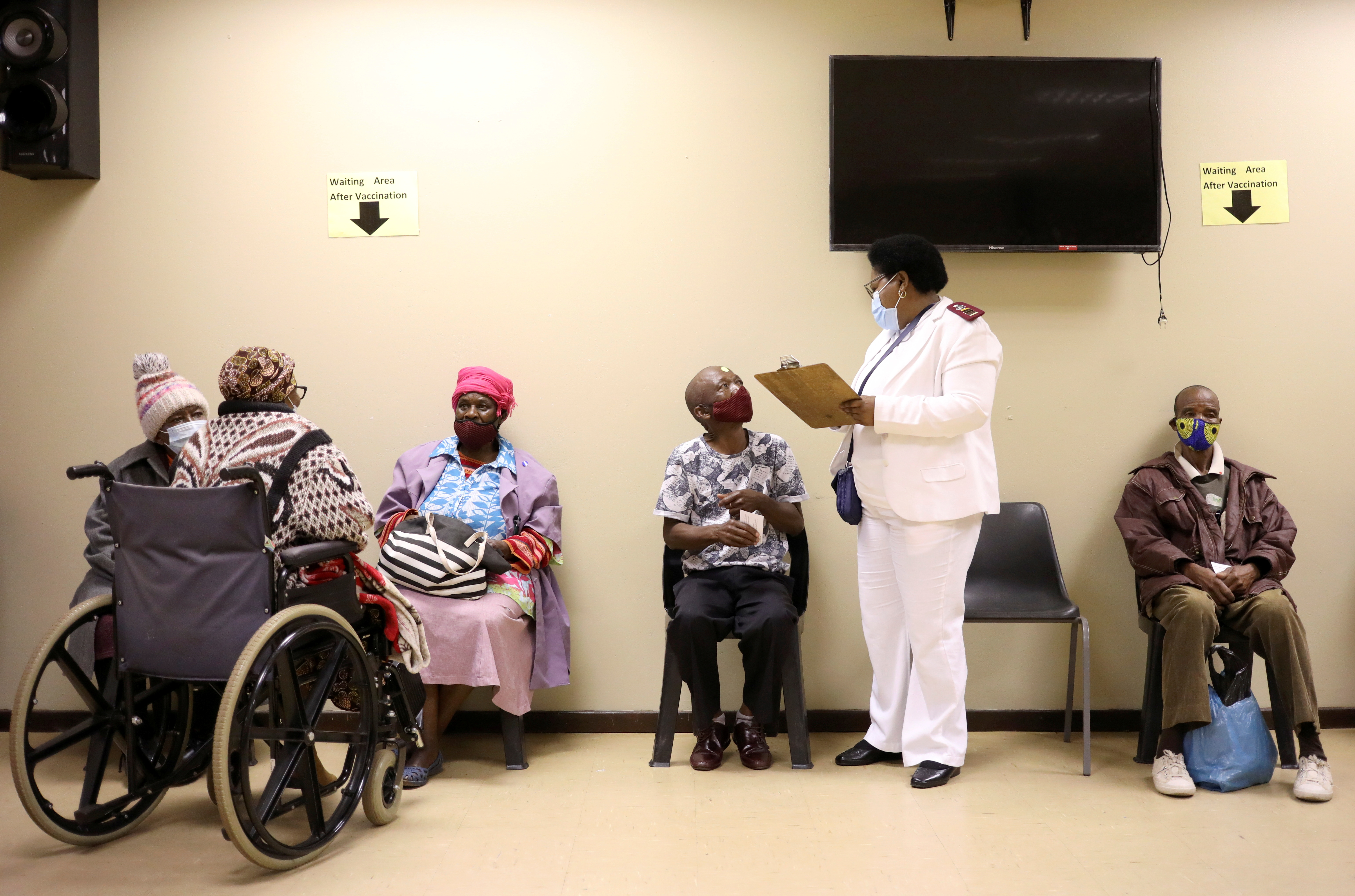 A nurse talks to a man following his vaccination