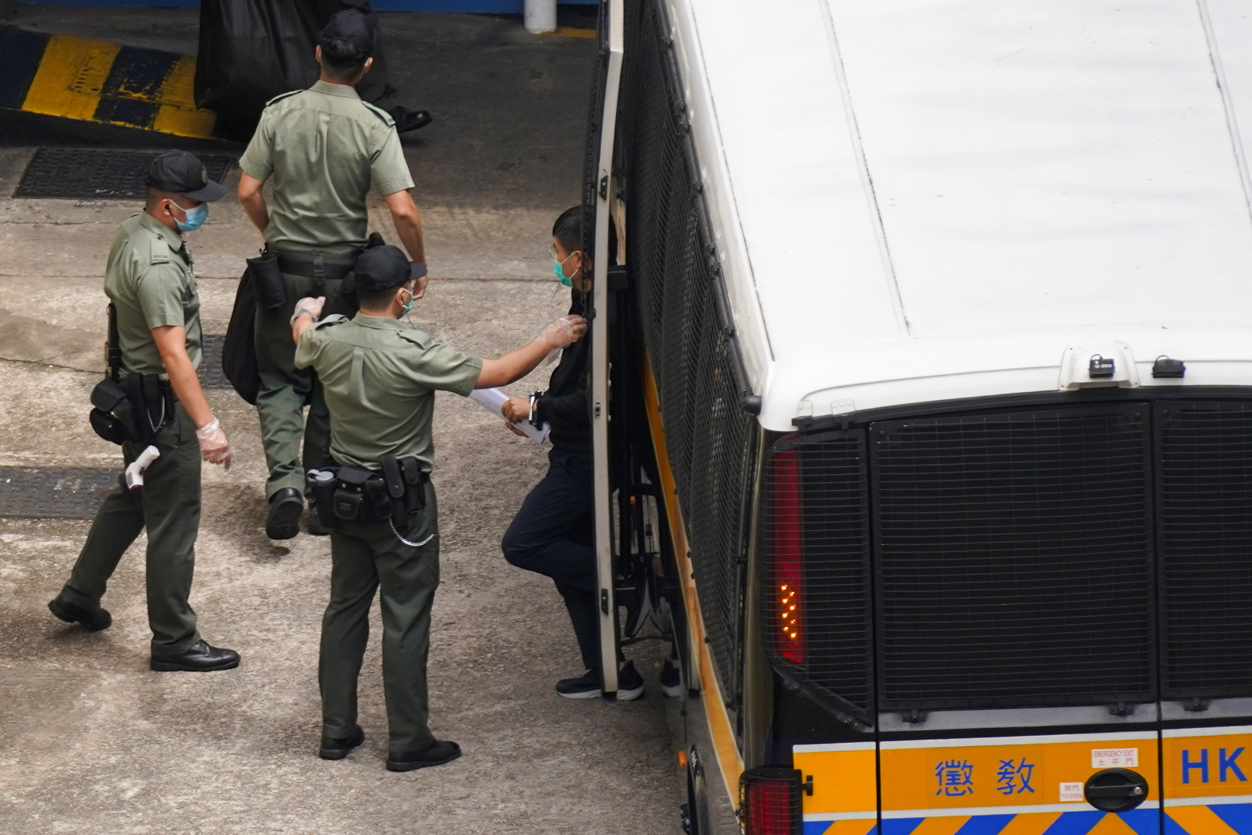 Apple Daily’s editor-in-chief, Ryan Law, arrives back at the detention centre after he was remanded in custody on Saturday