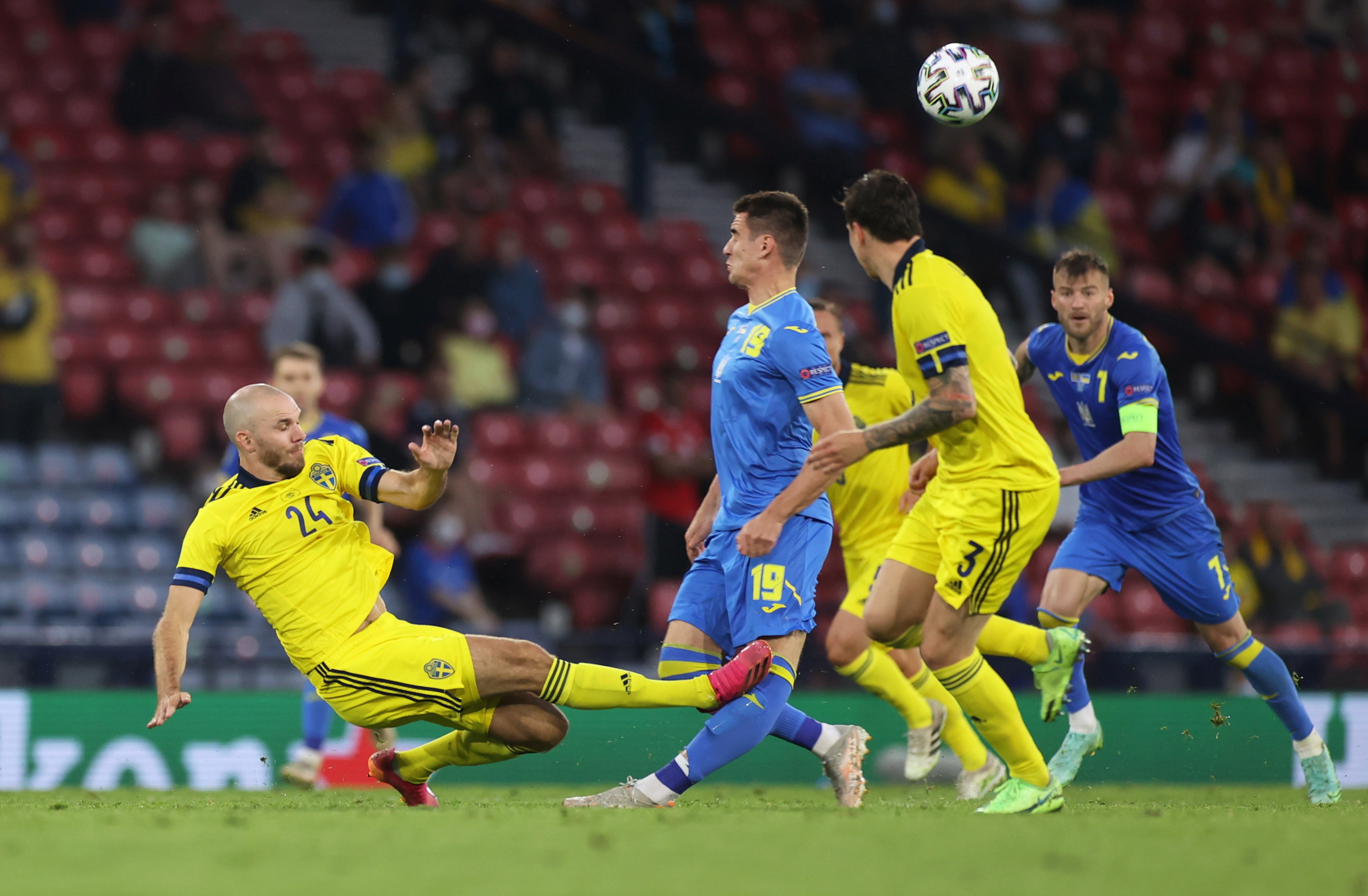 Sweden’s Marcus Danielson in action with Ukraine’s Artem Besyedin before being shown a red card by referee Daniele Orsato