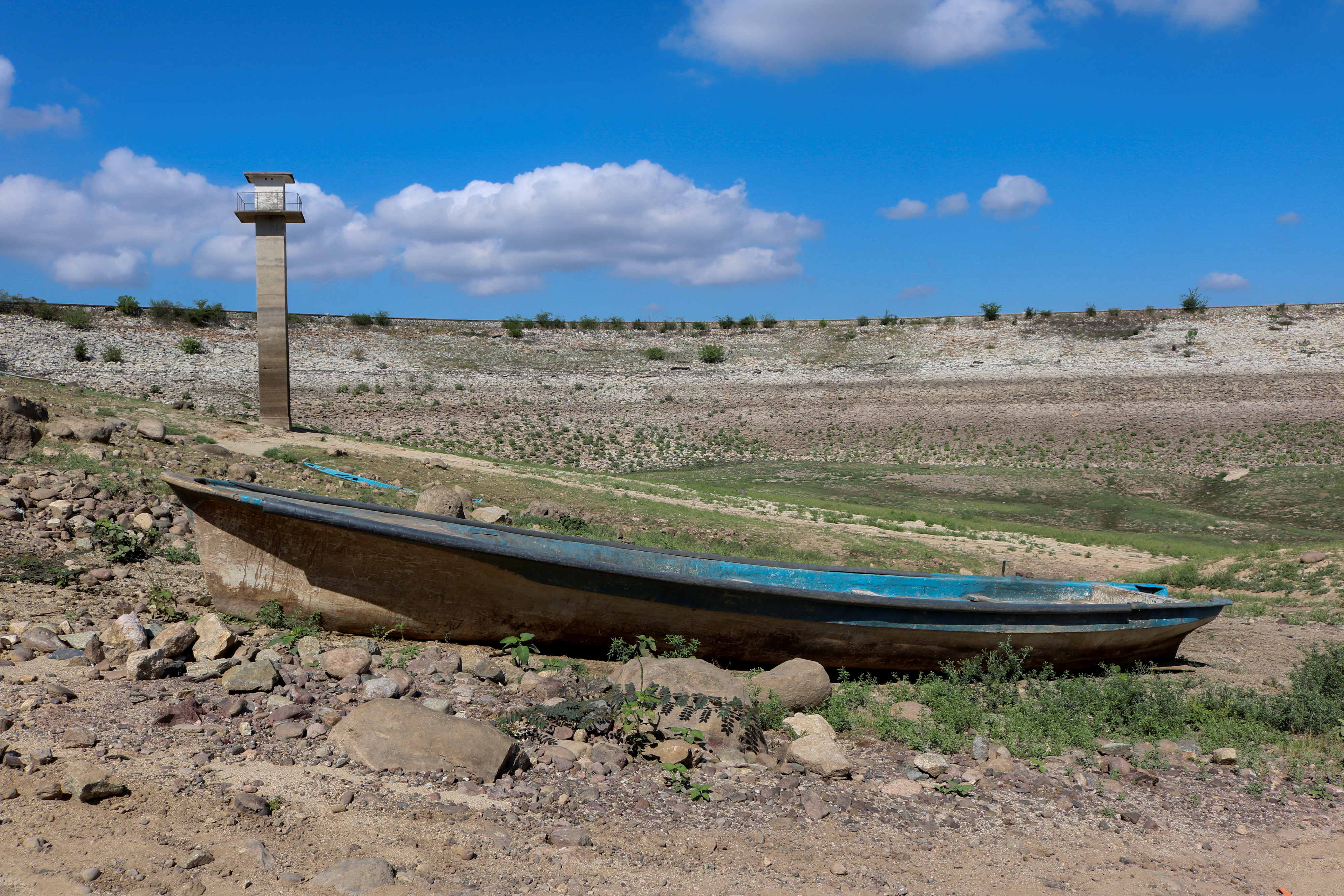 A boat lies on the dry ground of the Sanalona reservoir, which has low water levels due to a long-term drought in Culiacan, Sinaloa state, Mexico