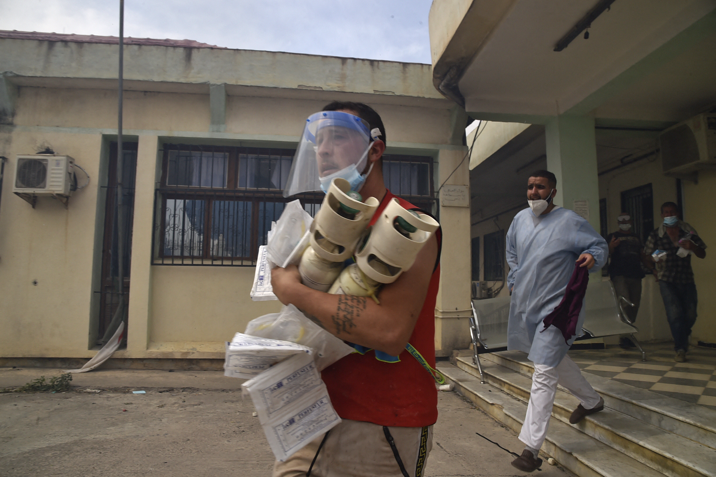 Medics evacuate a clinic during a wildfire in the hills of Kabylie, east of Algiers