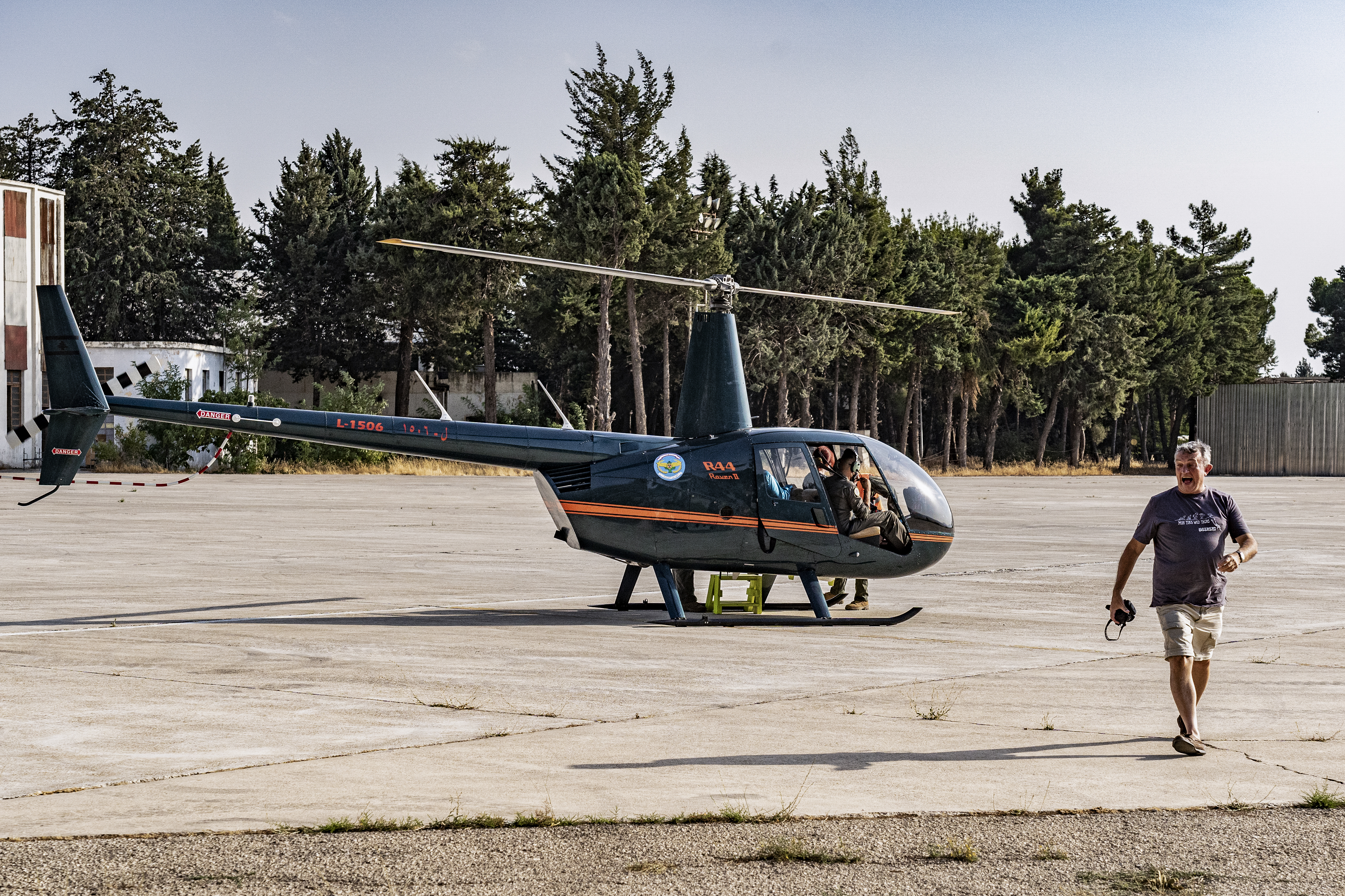A tourist finishes his helicopter tour with the Lebanese Air Force at Rayak Airbase in the Beqaa Valley, Lebanon. The Lebanese Army offering tourists helicopter tours to survive