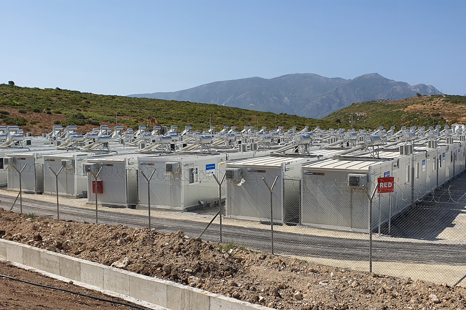 Some of the 350 asylum-seekers bussed here this week were grateful to move from an old camp in’Vathy but others say the new site will lead to further isolation