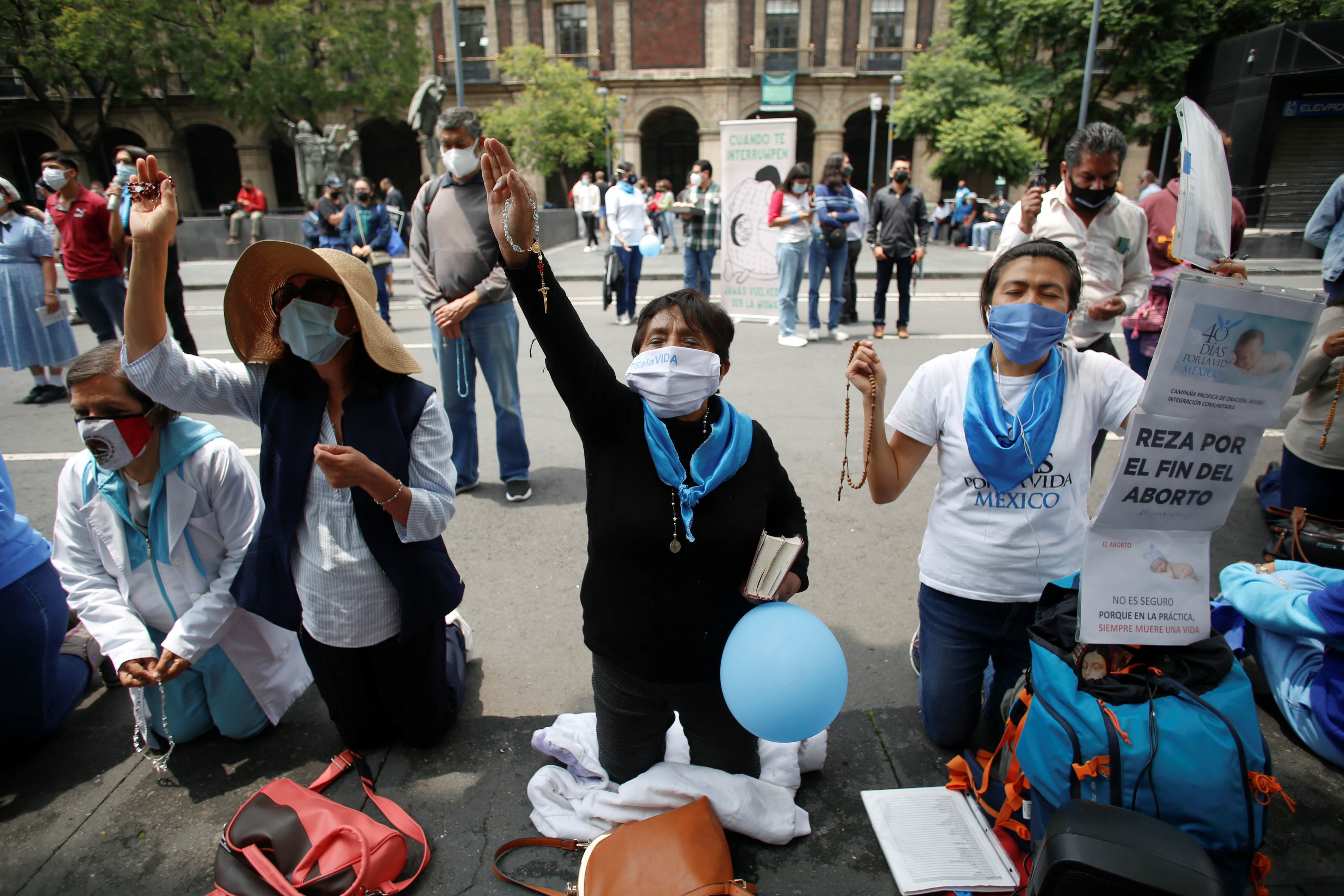 Catholics pray as they protest the decision of Mexico’s Supreme Court of Justice of the Nation (SCJN), in Mexico City on September 7