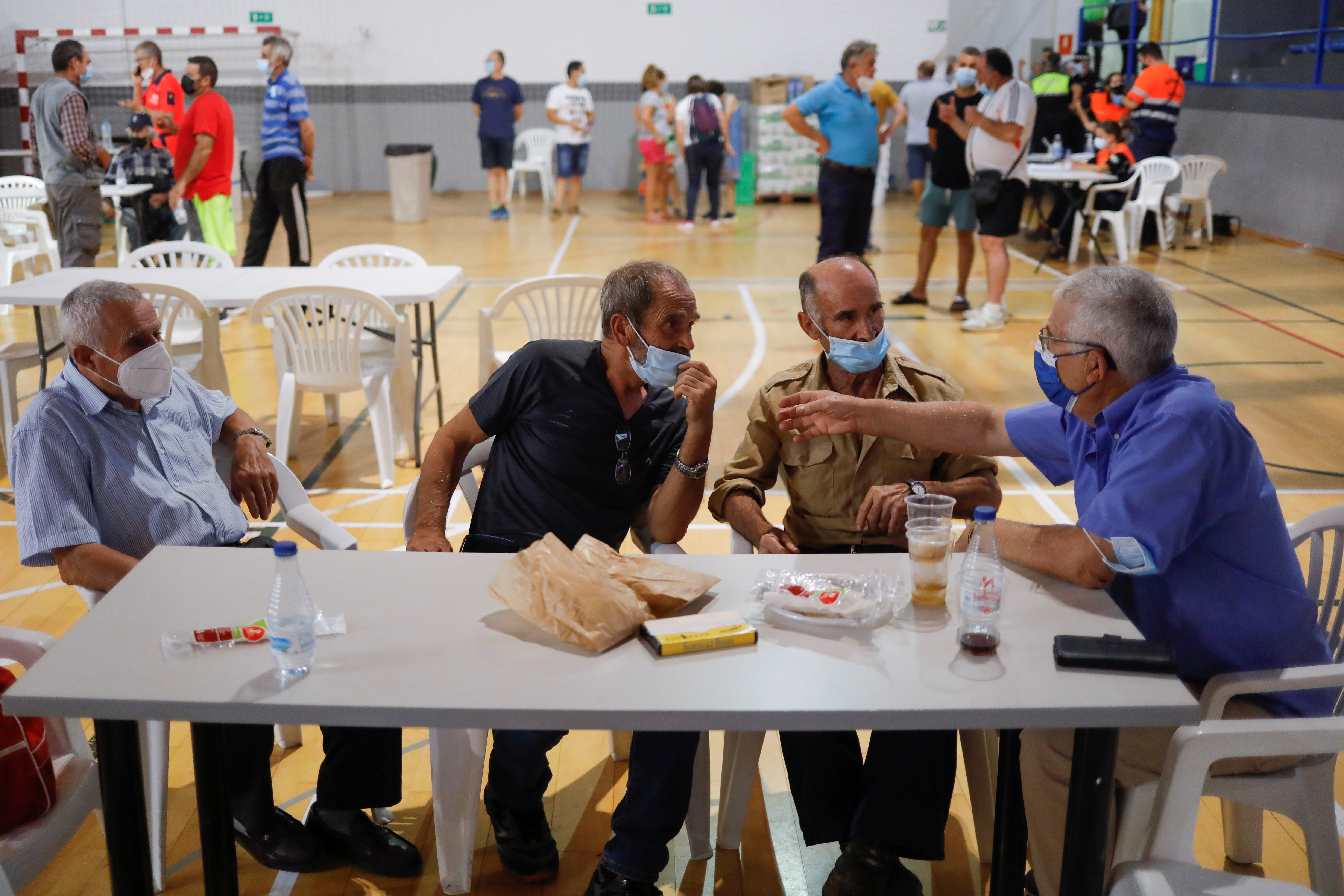 Evacuated residents rest inside a sports centre due to a wildfire on Sierra Bermeja mountain, in Ronda, near Estepona, Spain