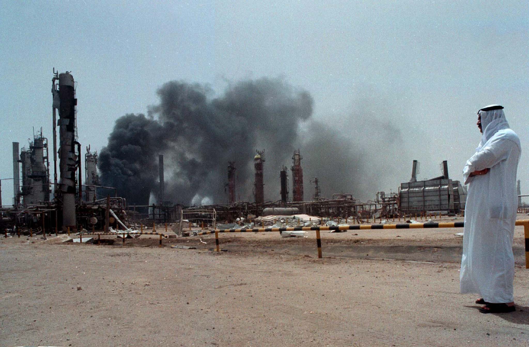 A Kuwaiti national looks at his country’s largest oil refinery burning after a gas leak caused a huge explosion on June 25, 2000