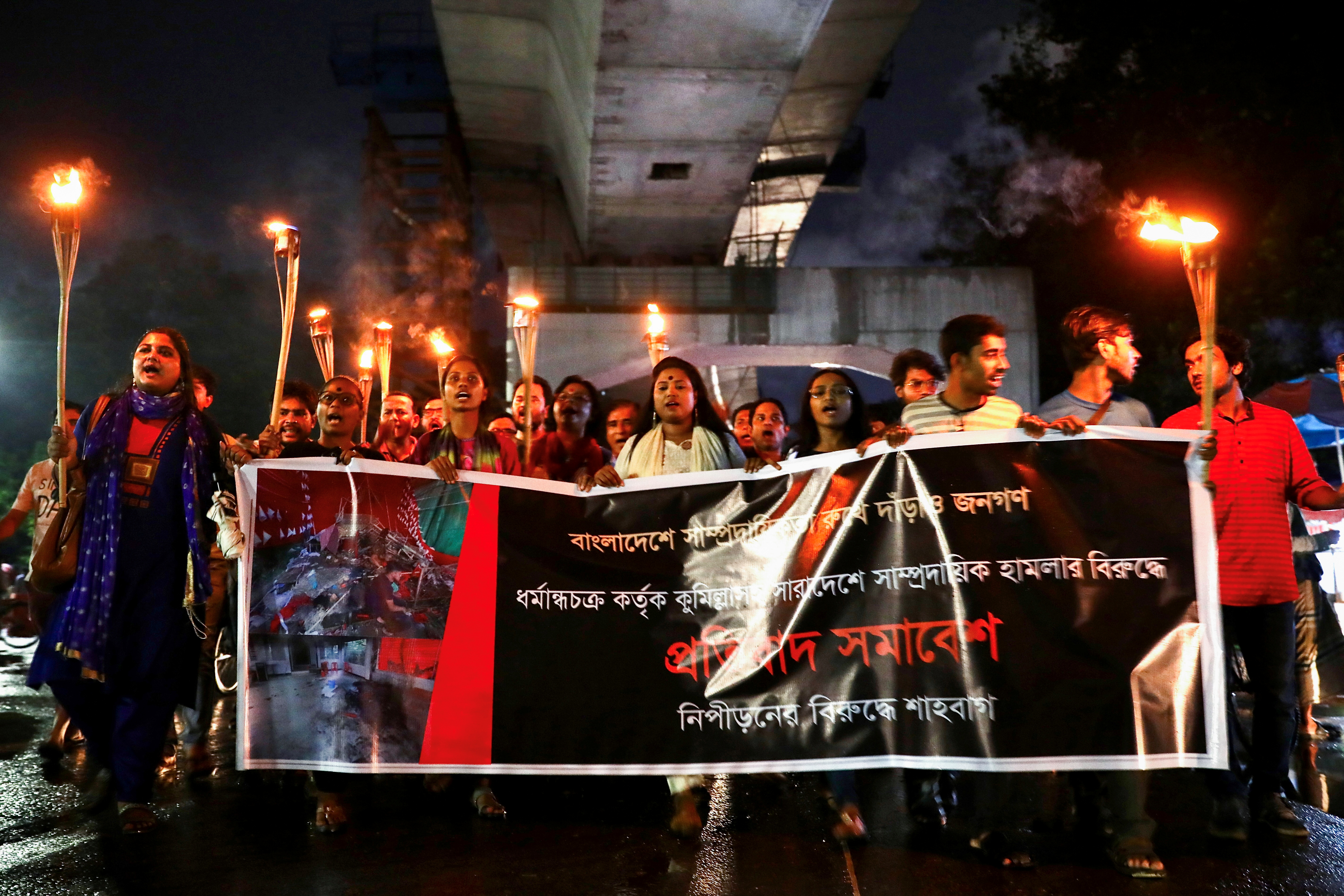 Bangladeshi activists hold a torch procession demanding justice for violence against Hindus, in Dhaka