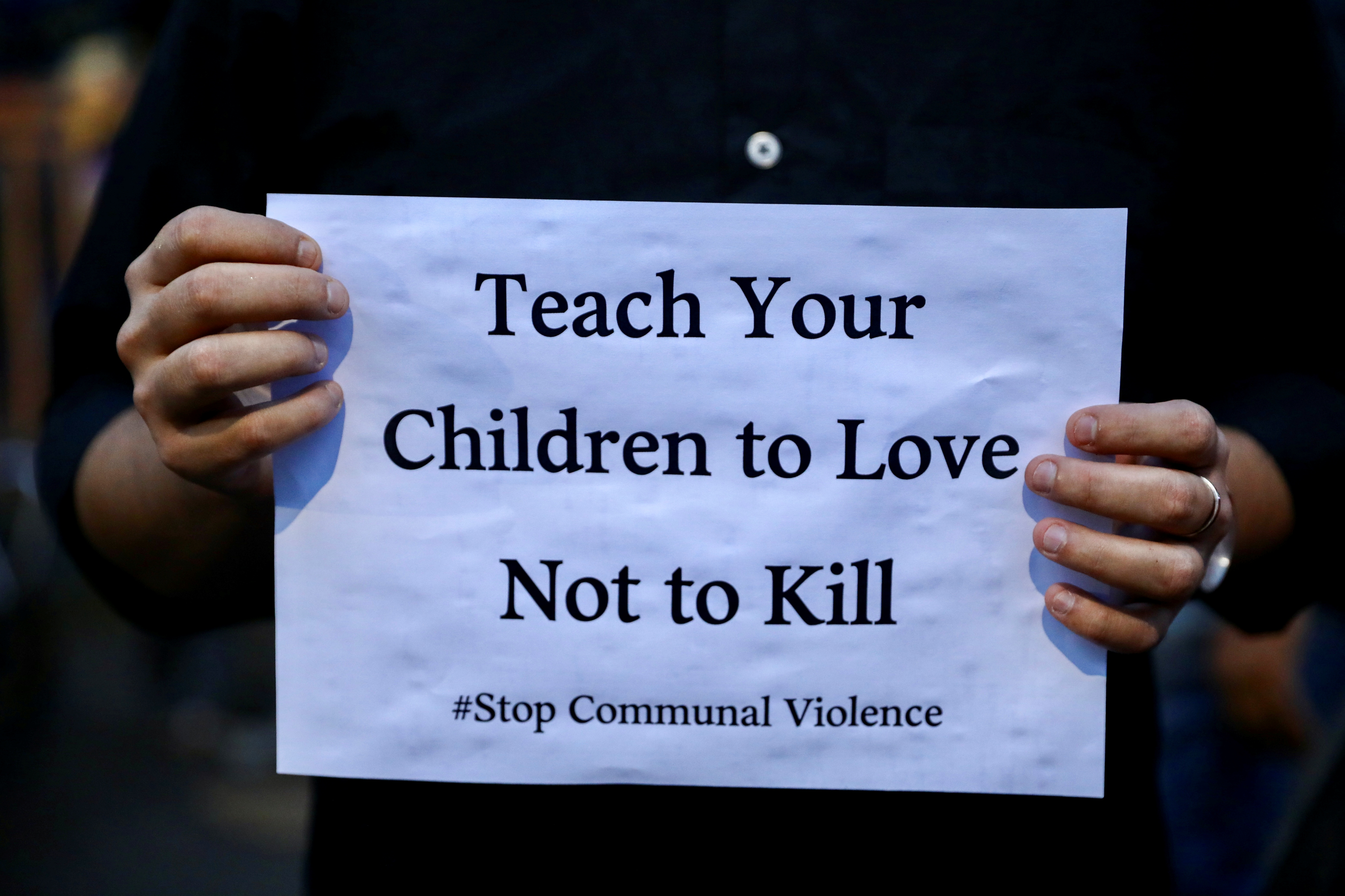 A protester holds a placard during a protest in Dhaka calling for an end to communal violence and demanding justice for the violence against Hindus