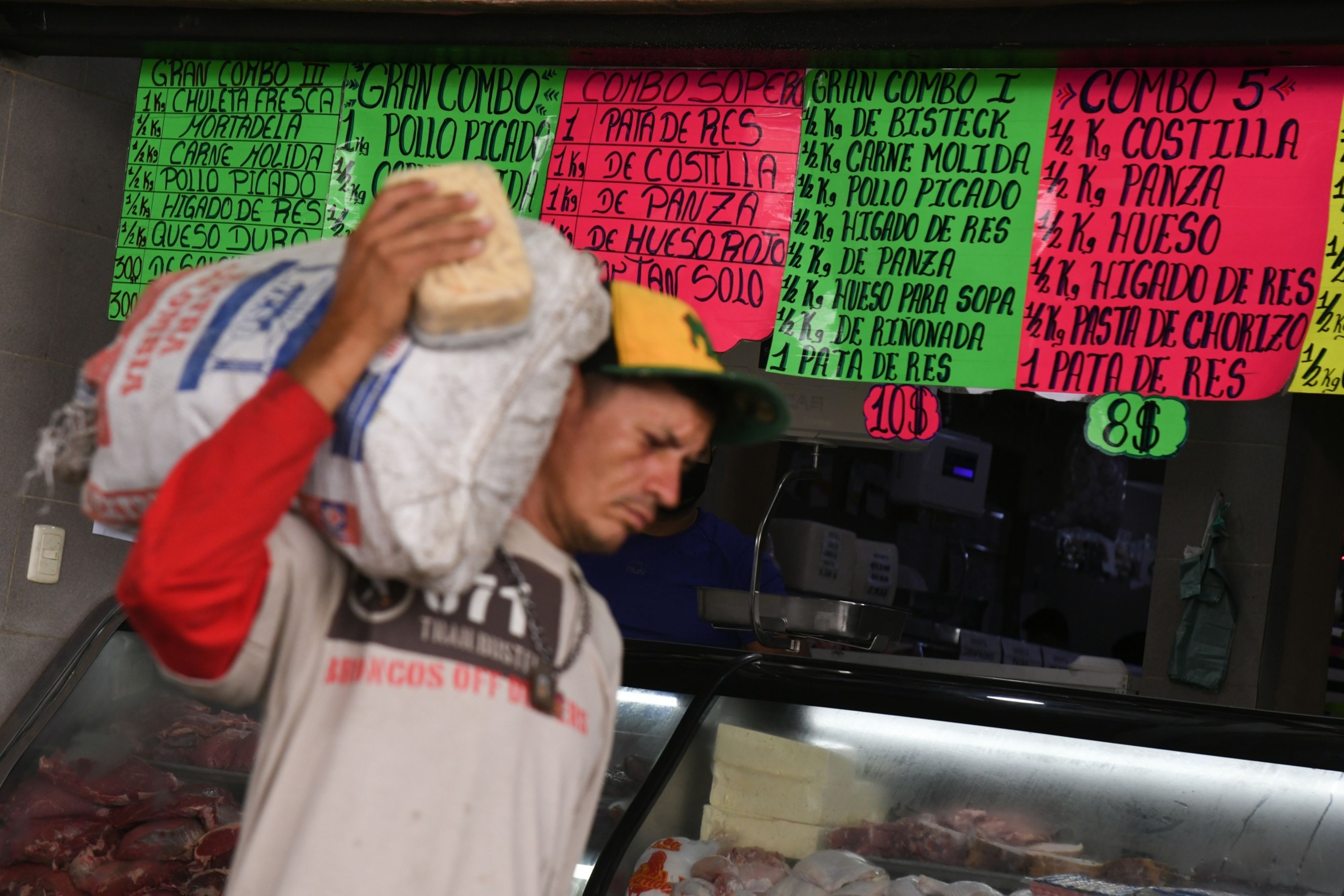 A butcher store lists prices in US dollars in the Petare neighborhood of Caracas, Venezuela, on Monday, October 4, 2021