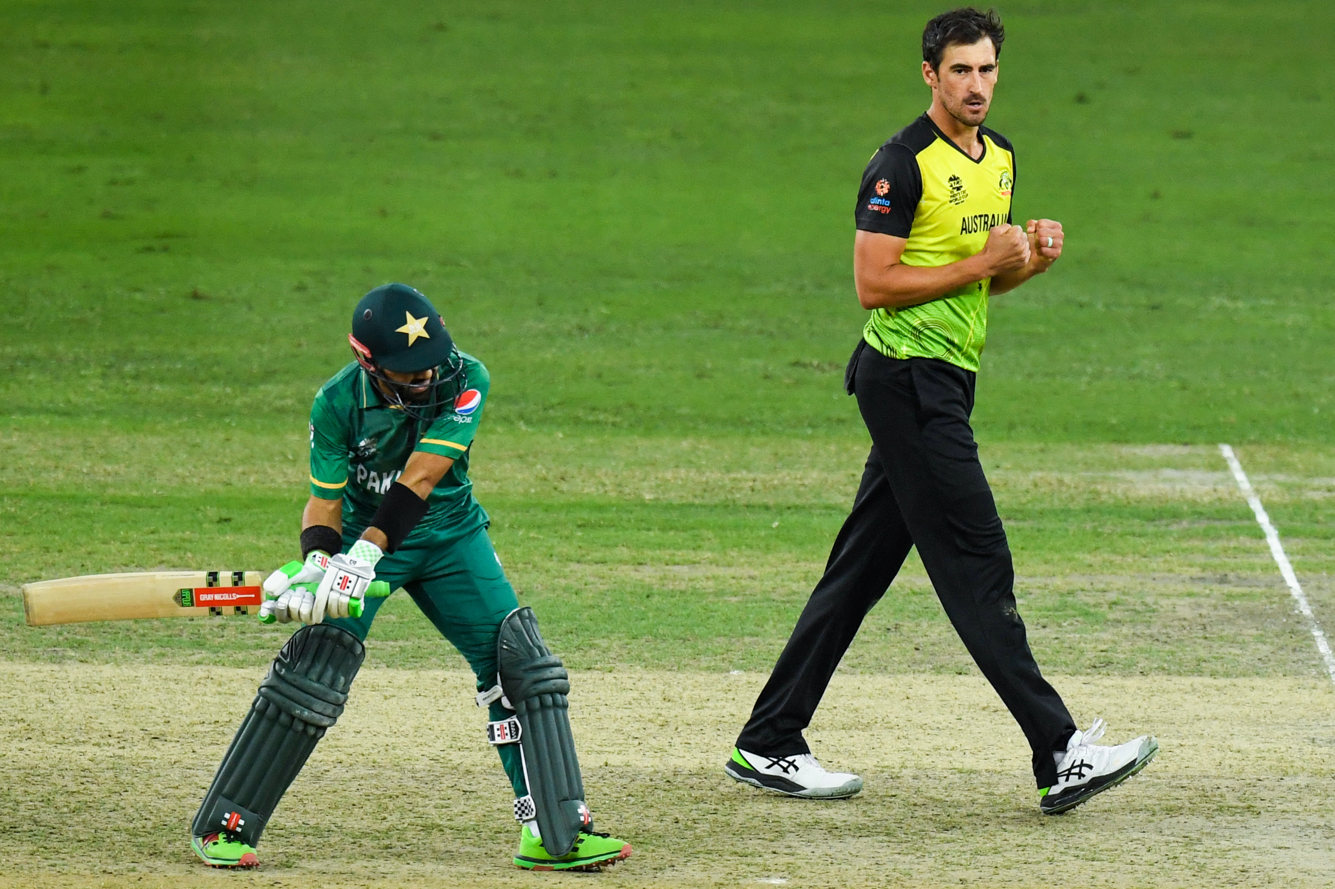 Australia’s Mitchell Starc (R) celebrates dimissing Pakistan’s Mohammad Rizwan during the ICC mens Twenty20 World Cup semi-final match between Australia and Pakistan at the Dubai International Cricket Stadium in Dubai on November 11, 2021.