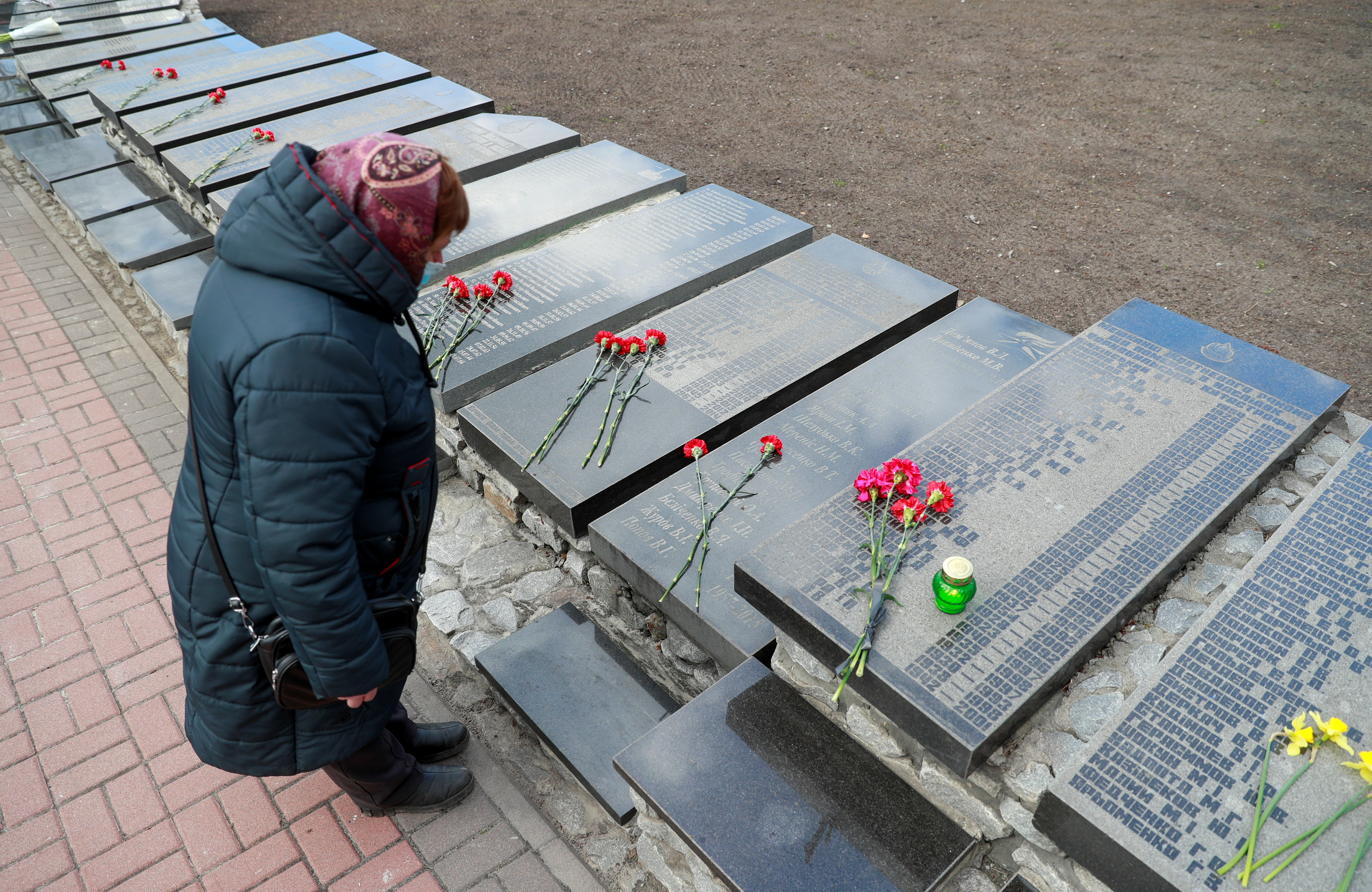 A woman attends a commemoration ceremony