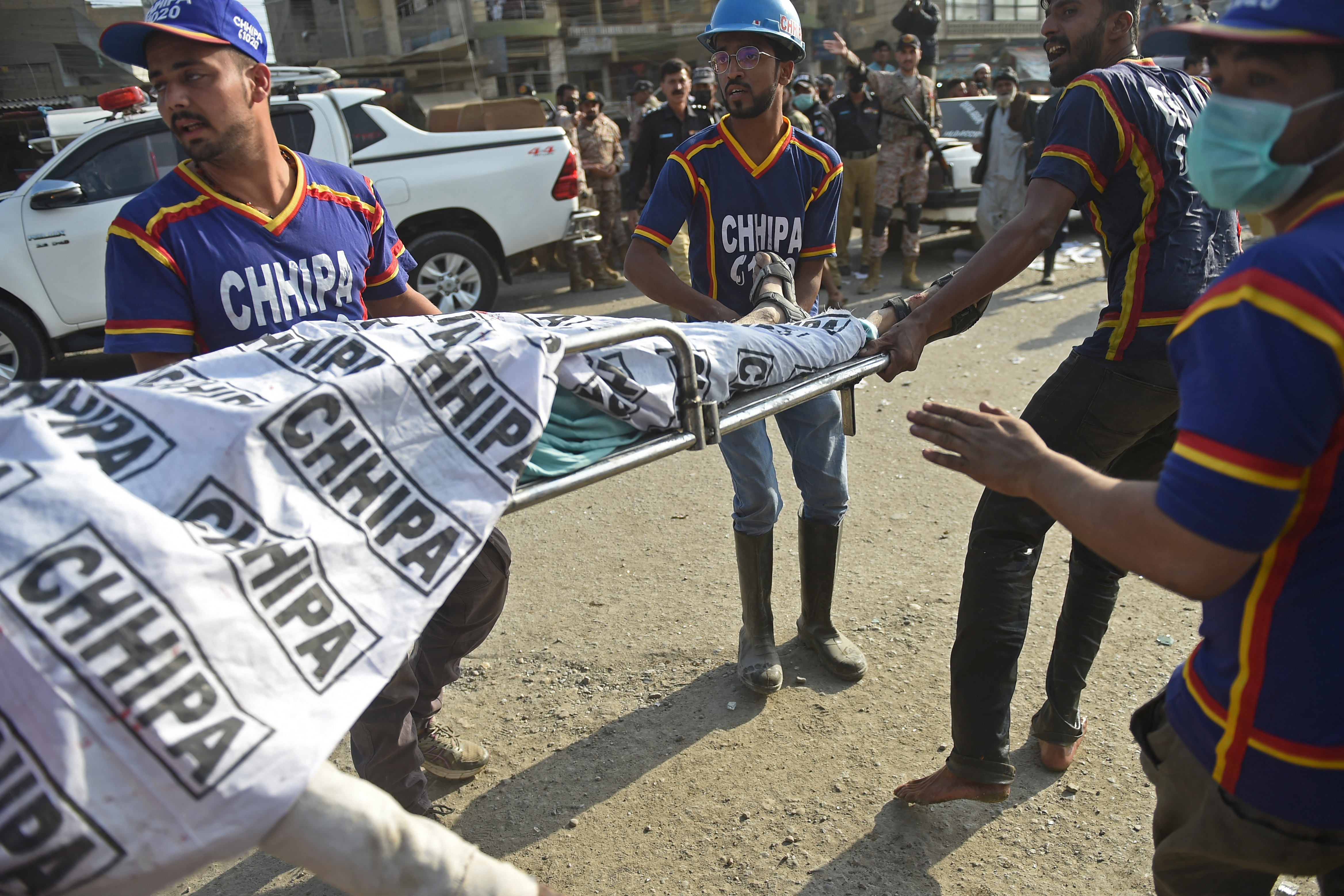 Rescuers carry the body of a victim who died in the gas blast