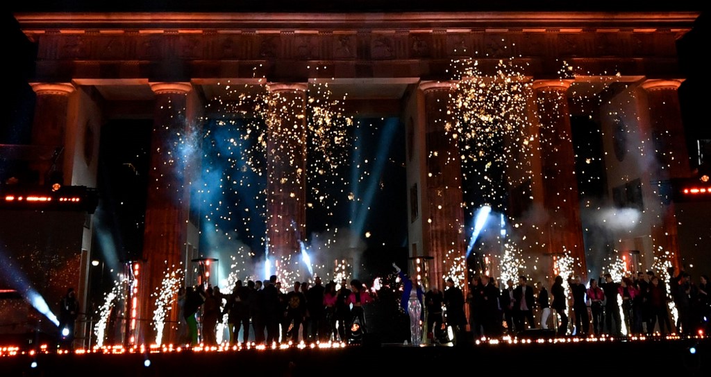 Germans gather near the Brandenburg Gate in Berlin to celebrate the New Year on Saturday