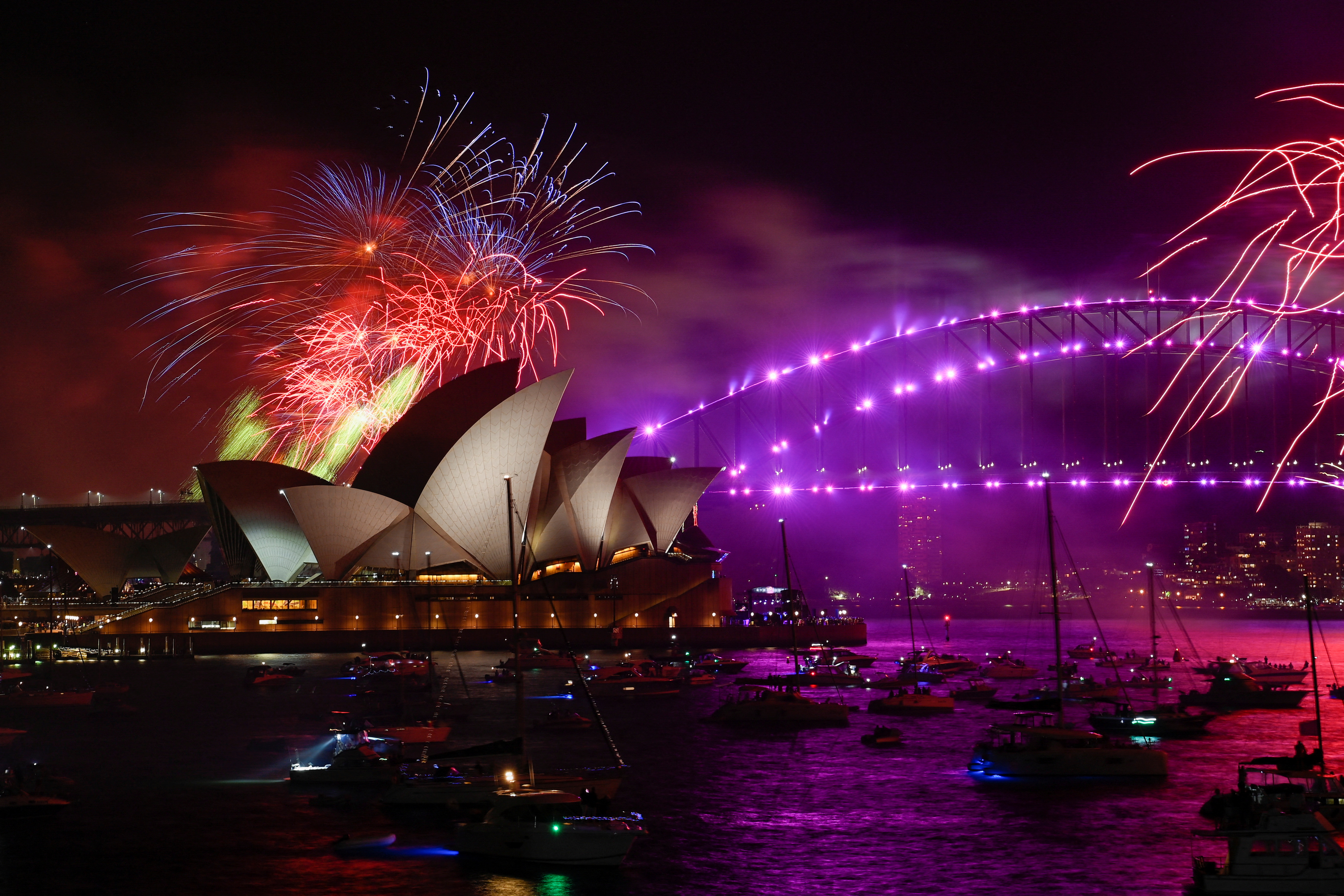 The Sydney Opera House is seen as fireworks explode over Sydney Harbour during New Year’s Eve celebrations in Sydney, Australia