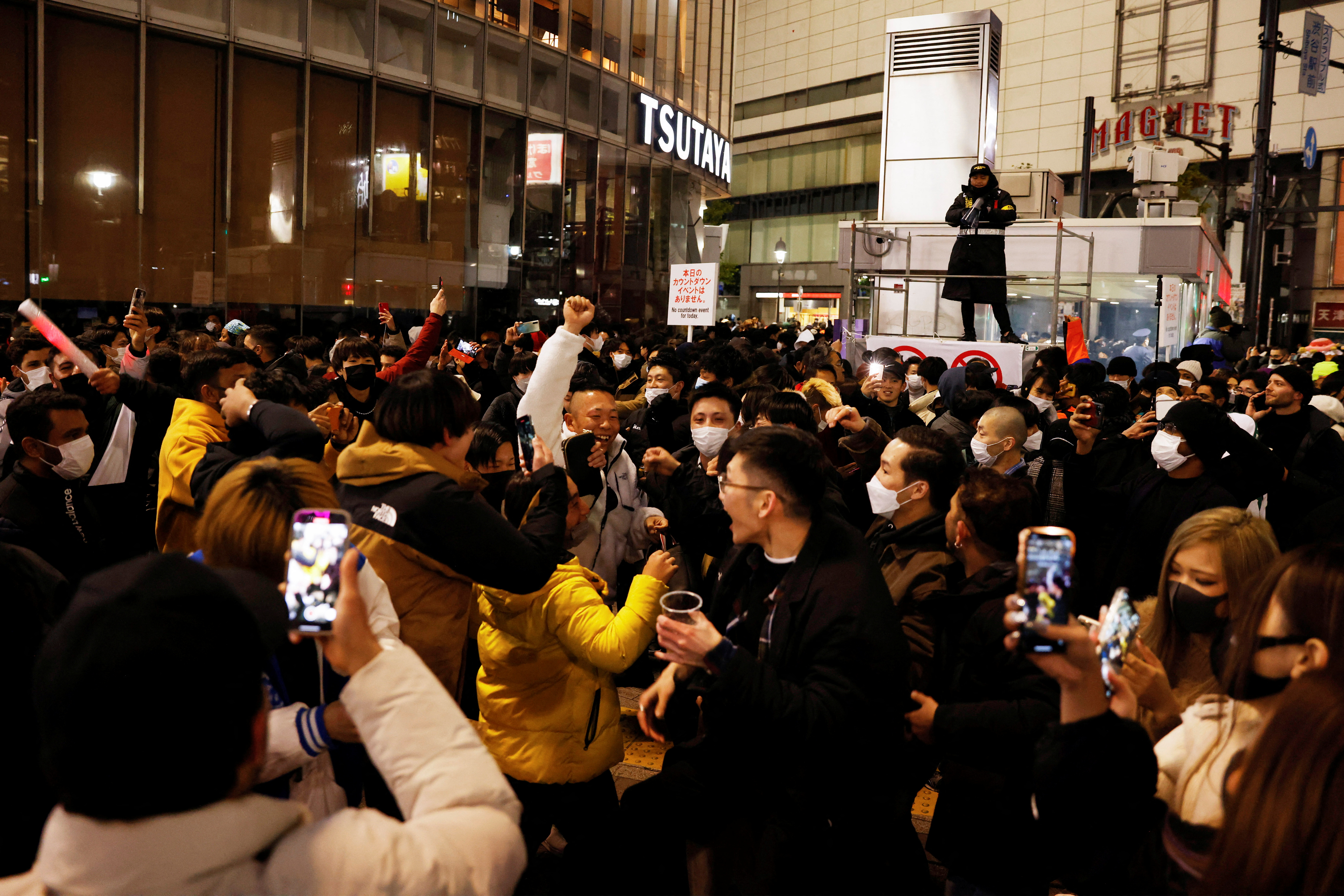 Revellers celebrate the New Year at the Shibuya crossing in Tokyo, Japan