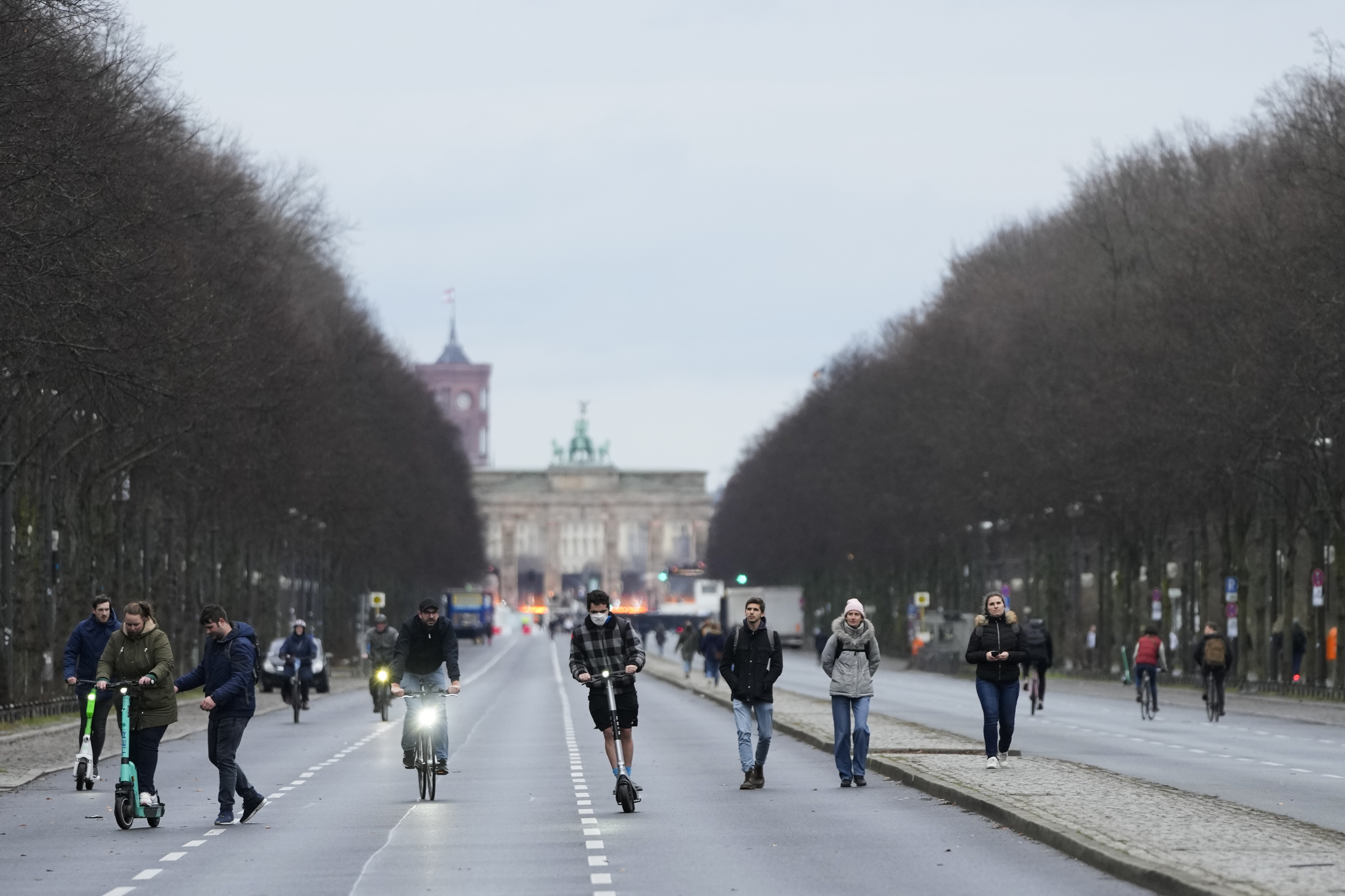 Only a few people walk on the boulevard ‘Strasse des 17. Juni’ in front of the Brandenburg Gate, Berlin, Germany