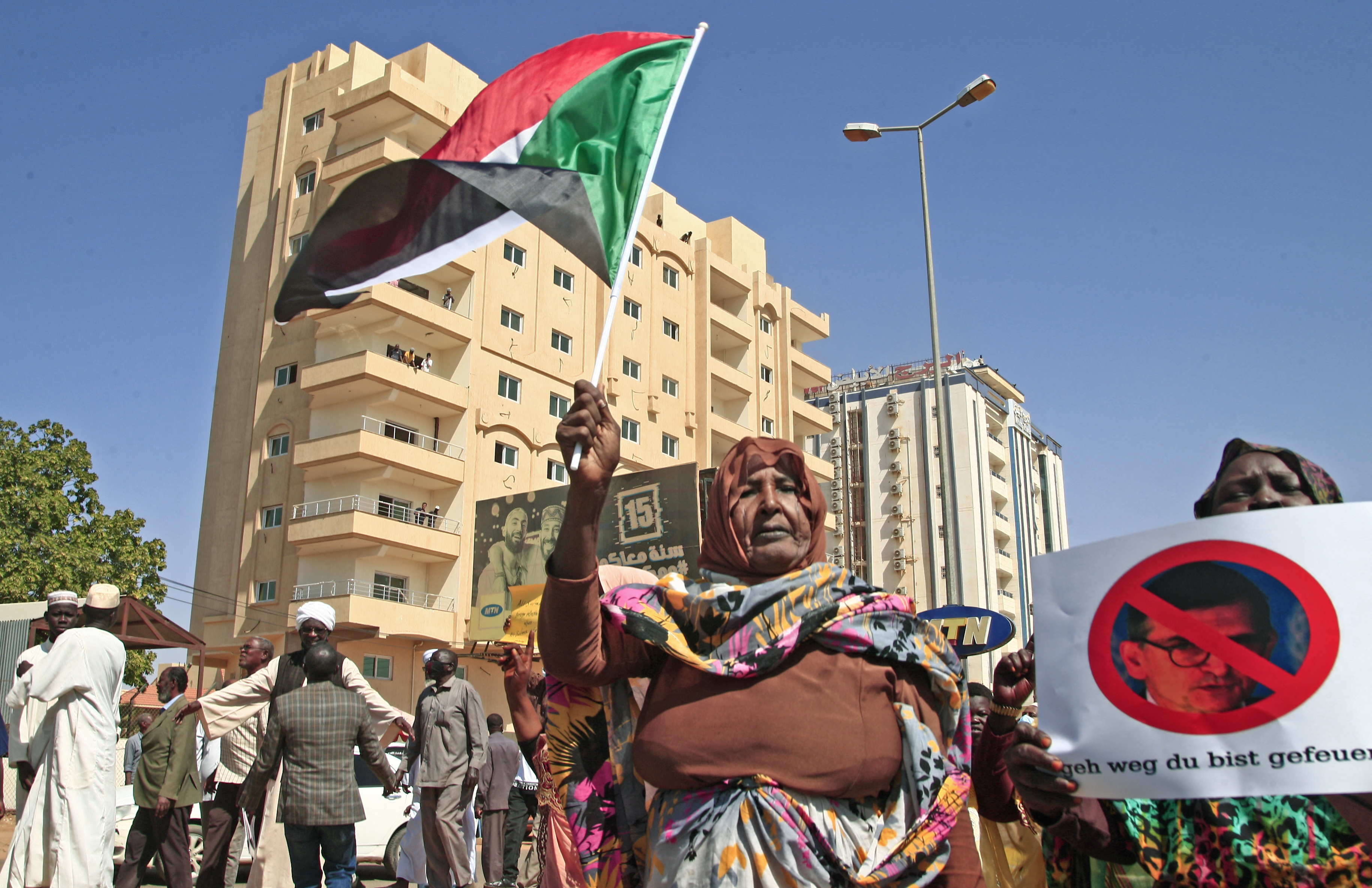 Sudanese pro-military protesters chant slogans as they demonstrate against a UN bid to resolve a political crisis outside the Khartoum office of the UN Transition Assistance Mission Sudan in the Sudanese capital on January 26, 2022. 