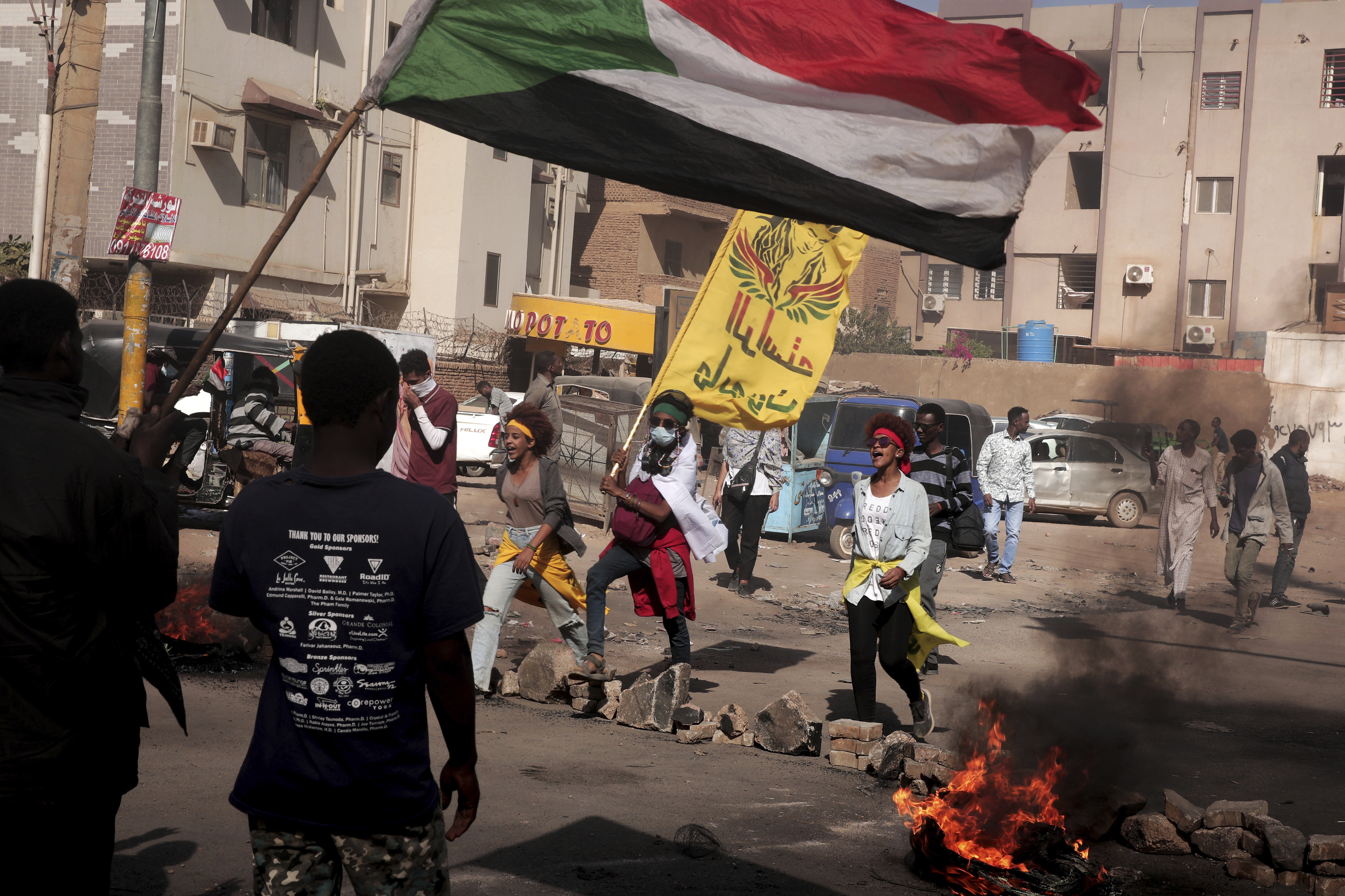 People burn tyres and chant slogans during a demonstration in Sudan