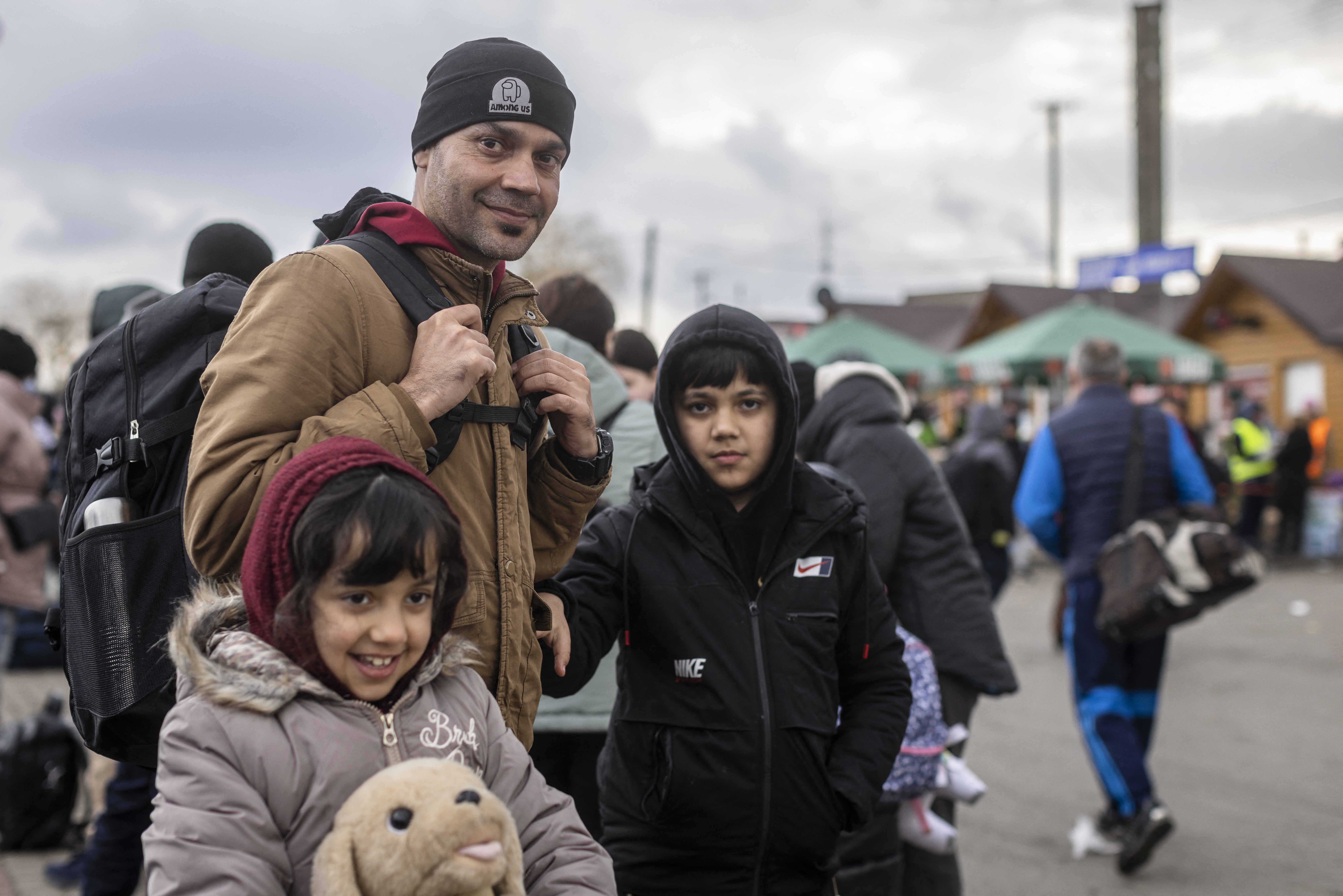 Ajmal Rahmani from Afghanistan and his children are seen at the Medyka pedestrian border crossing fleeing the conflict in Ukraine
