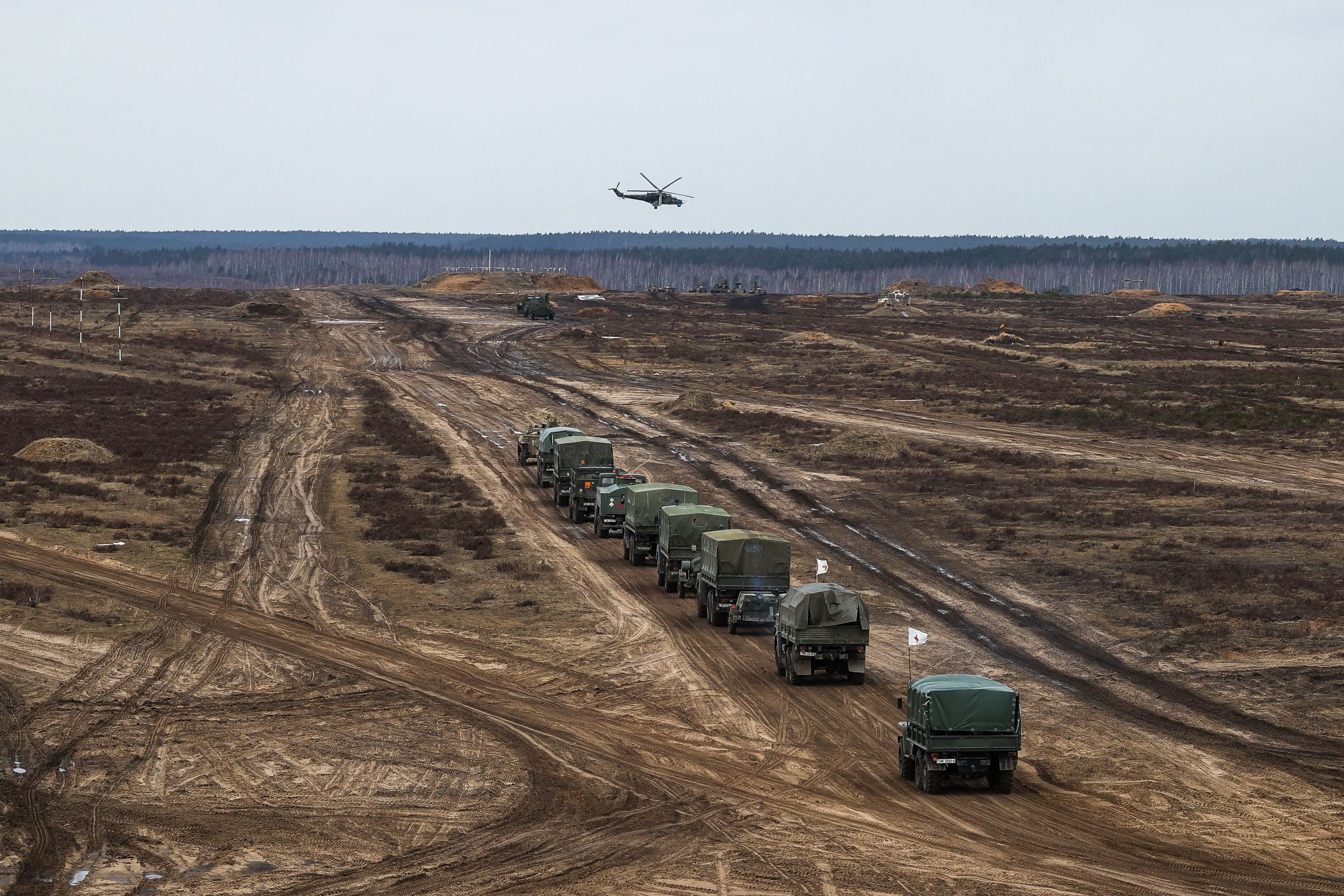 A helicopter flies over troops during the joint military drills of the armed forces of Russia and Belarus at a firing range in the Brest Region, Belarus