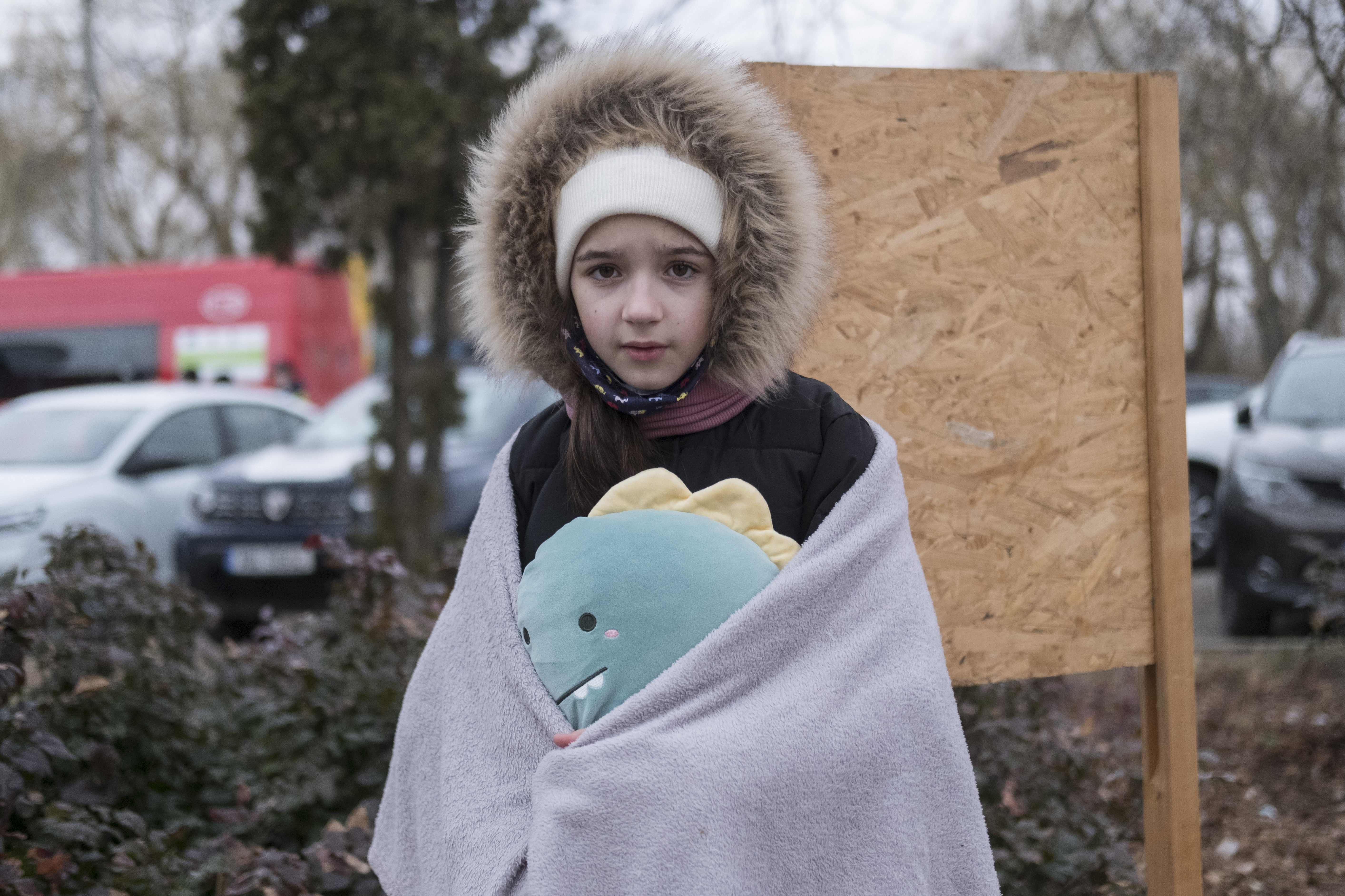 Sofia, 11 years old, from Chernivtsi, holds her favorite toy after arriving in Romania at Siret with her mother and brother.