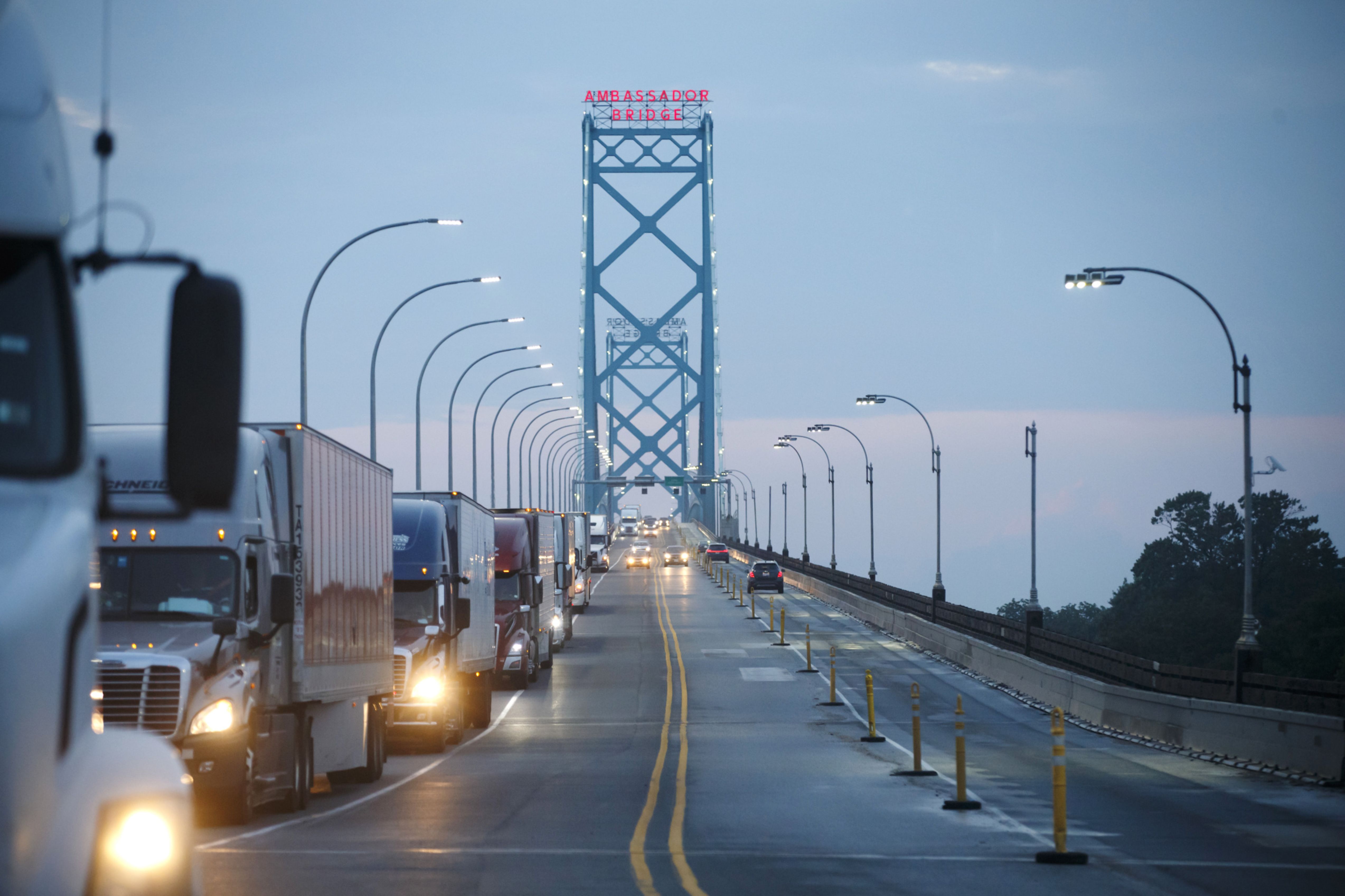 Commercial trucks and passenger vehicles drive across Ambassador Bridge on the Canada-U.S. border in Windsor, Ontario, Canada
