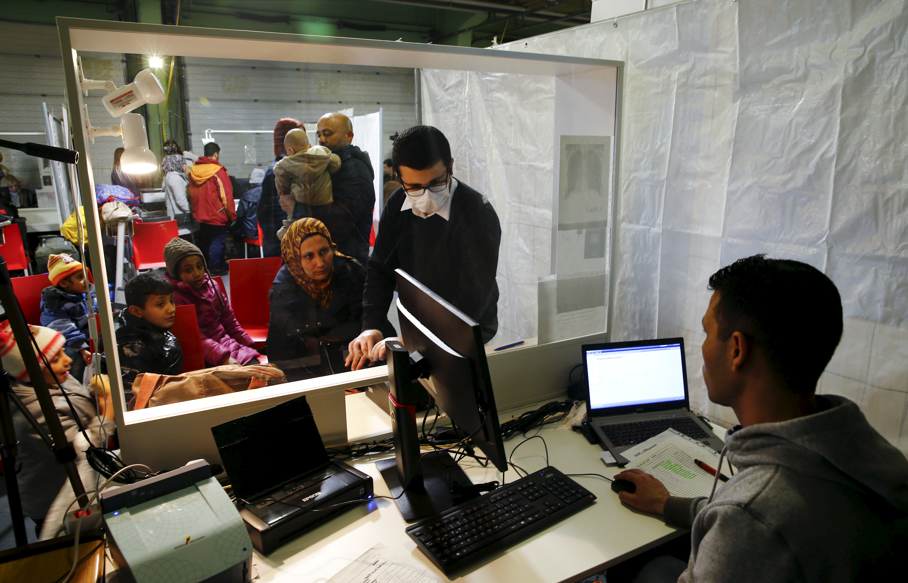 Wafy Al-Hamoud Alkhaldy, 36, and his wife Asma Al Saleh, 33, from the eastern Syrian town of Deir ez-Zor are seen together with their six children aged from five months old to 11 years old to register for the so-called "Ankunftsnachweis", an initial German registration document for migrants, at the former British Harewood barracks in Herford, western Germany February 22, 2016. Wafy and Asma left Syria together with their six children aged from 5 month to 11 years after their home was destroyed by an airstrike. The family finally were able to cross the Syrian-Turkish border following a 10km march after 14 unsuccessfull attempts early in January 2016. After paying $600 for each person to people traffickers the family reached the Greek island of Lesbos from where they took the so-called Balkan-Route to Germany. REUTERS/Wolfgang Rattay