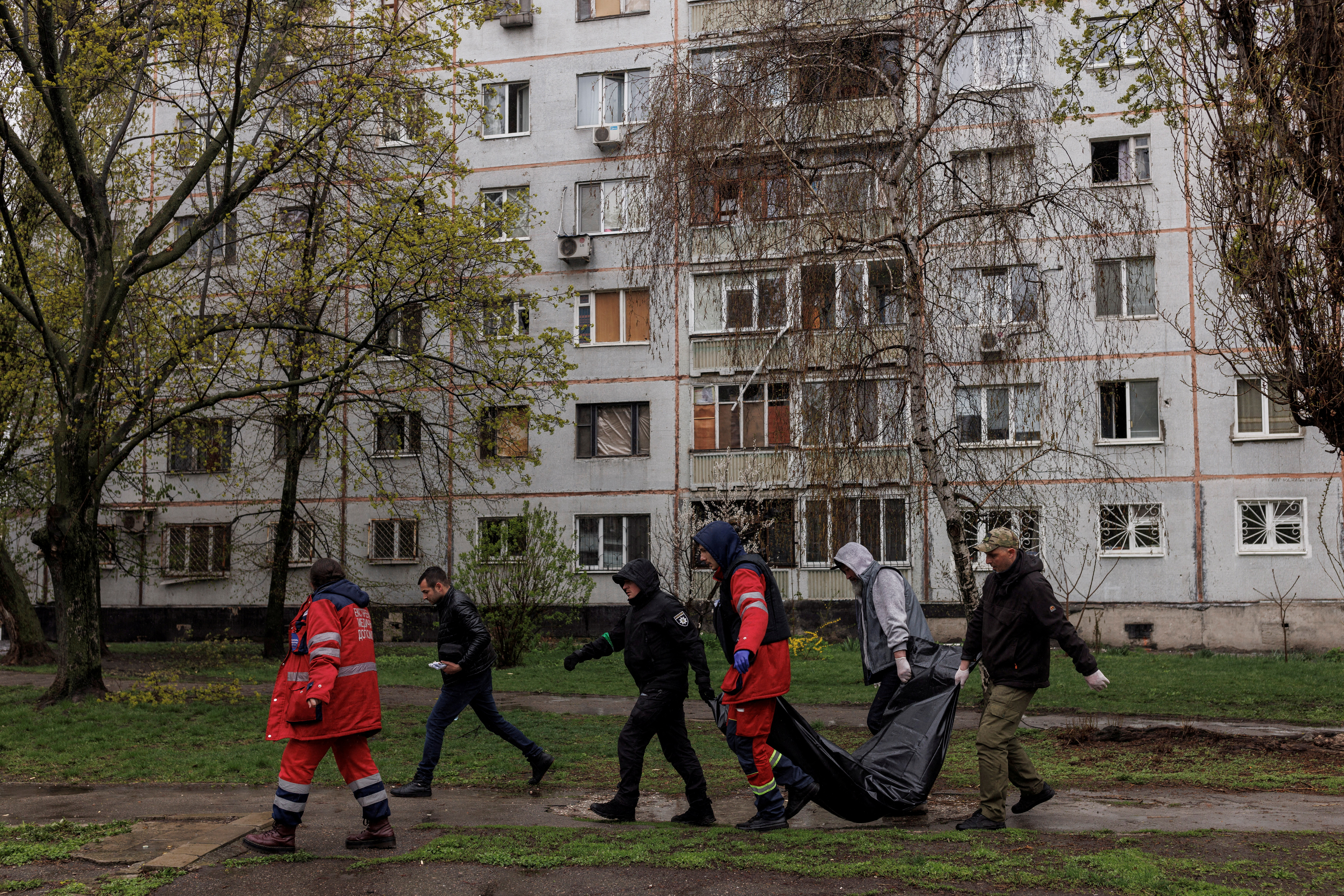 Medical workers and first responders retrieve the body of Victor Gubarev