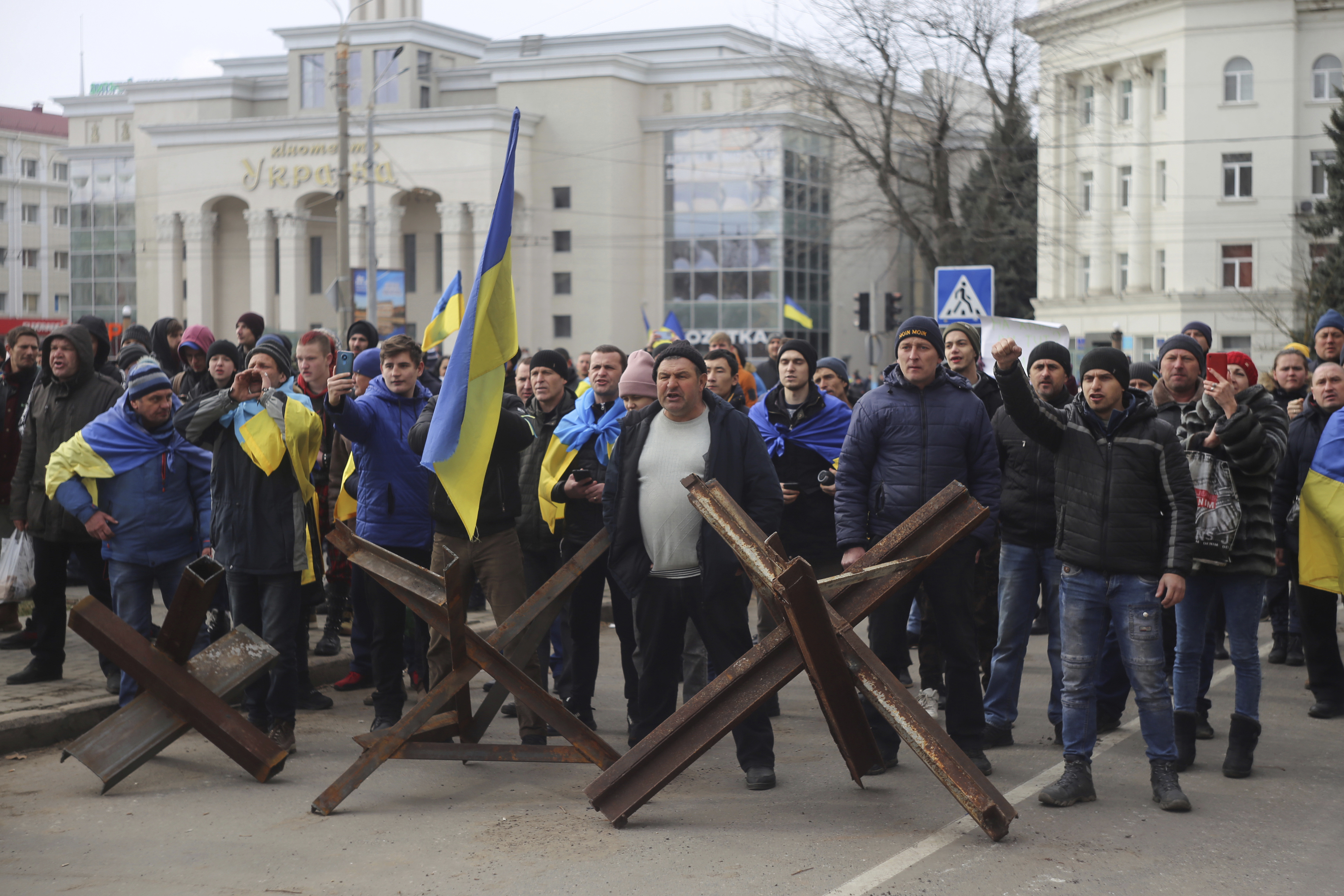 People shout toward Russian army soldiers during a rally against the Russian occupation in Svobody (Freedom) Square in Kherson, Ukraine, Monday, March 7, 2022. Ever since Russian forces took the southern Ukrainian city of Kherson in early March, residents sensed the occupiers had a special plan for their town. Now, amid a crescendo of warnings from Ukraine that Russia plans to stage a sham referendum to transform the territory into a pro-Moscow "people's republic," it appears locals guessed right. (AP Photo/Olexandr Chornyi)