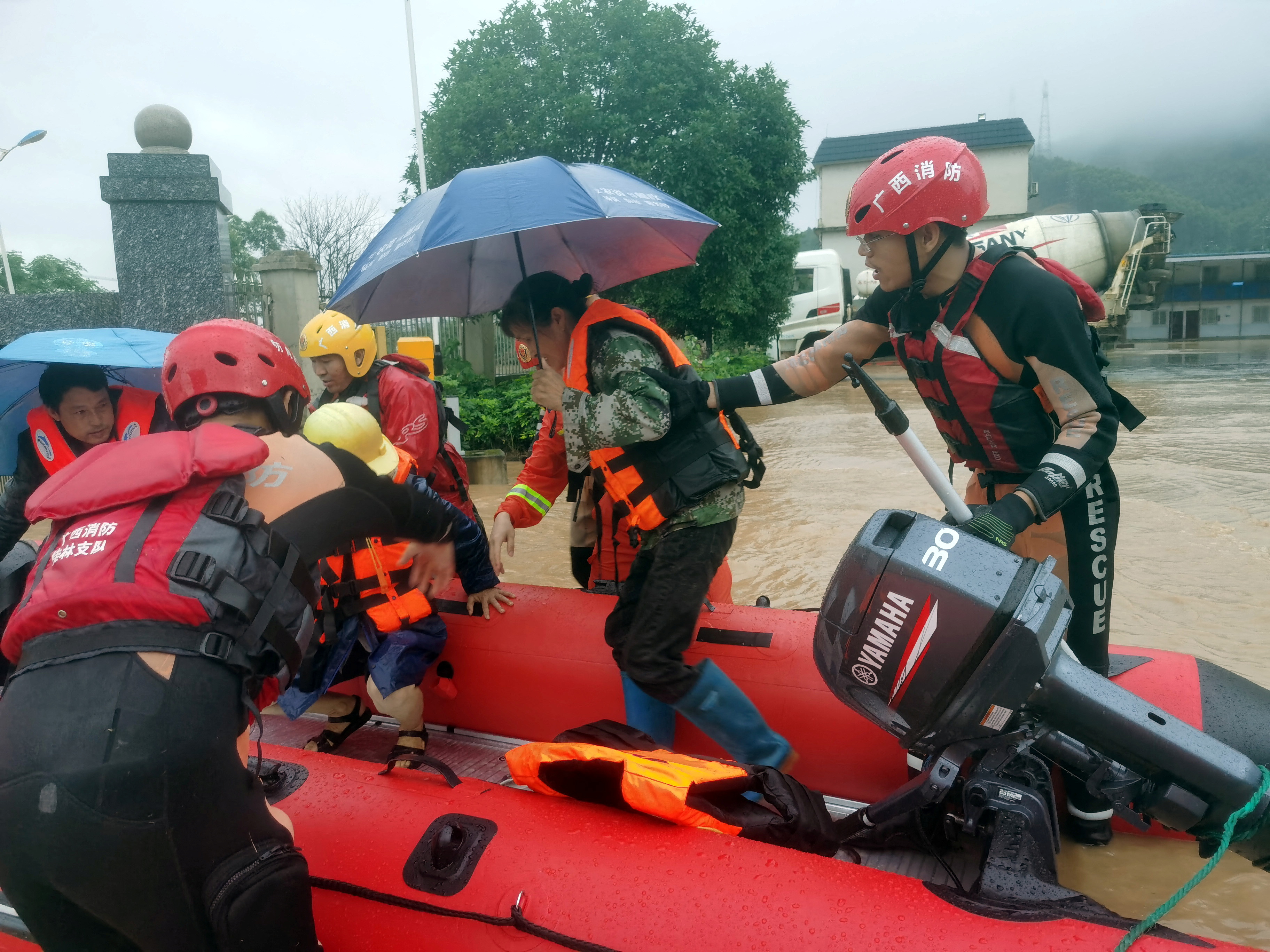 Rescue workers evacuate flood-affected residents with a dinghy following heavy rainfall in Yongfu county of Guilin, Guangxi Zhuang autonomous region, China on June 17, 2022 [CNS photo via Reuters]
