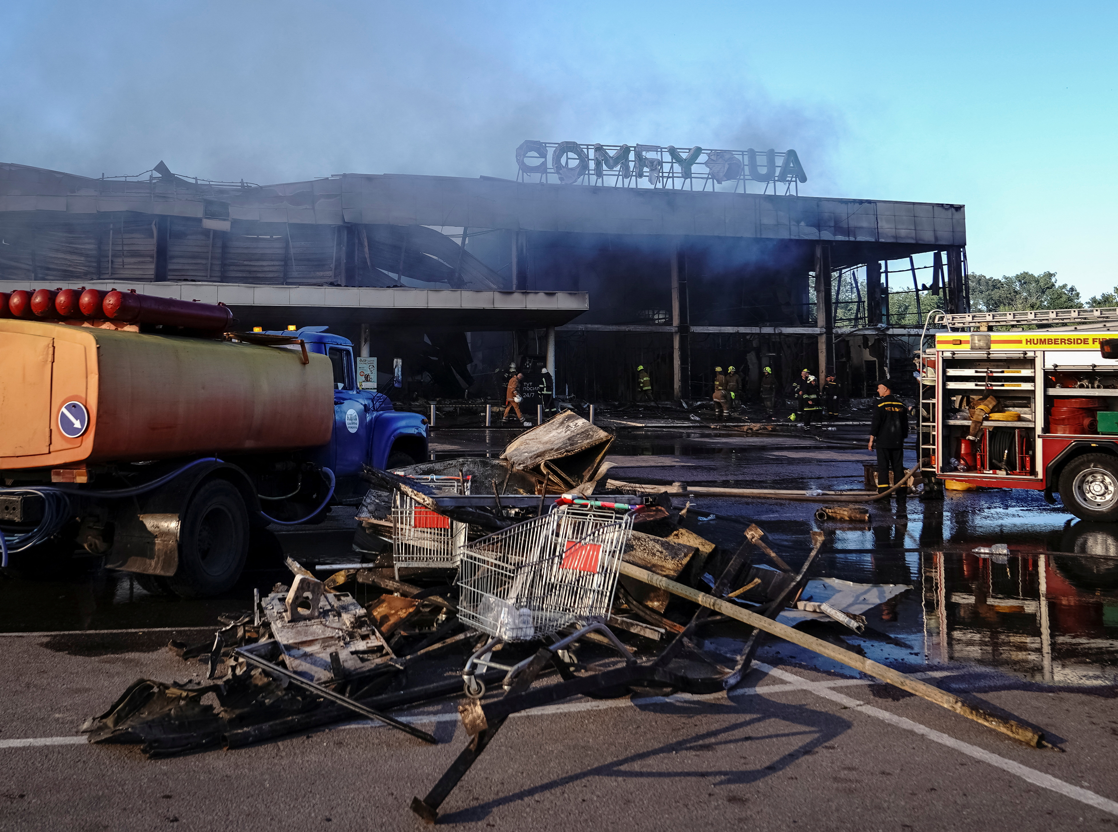 Rescuers work at a shopping mall hit by a Russian missile attack, in Kremenchuk, Poltava region, Ukraine