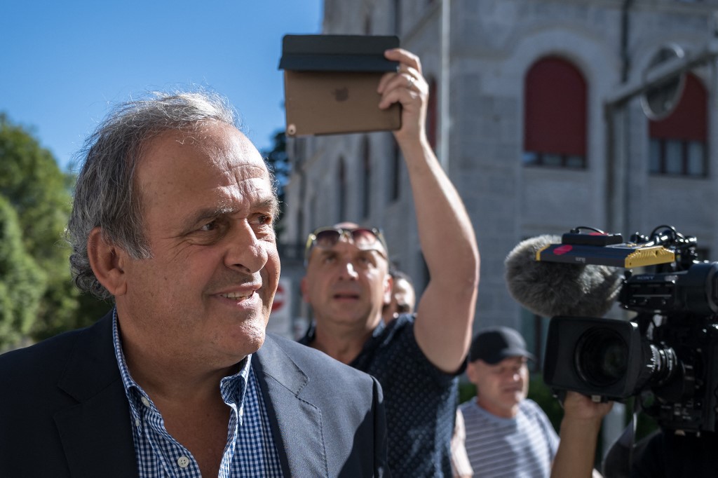 Platini surrounded by journalists as he arrives at Switzerland’s Federal Criminal Court