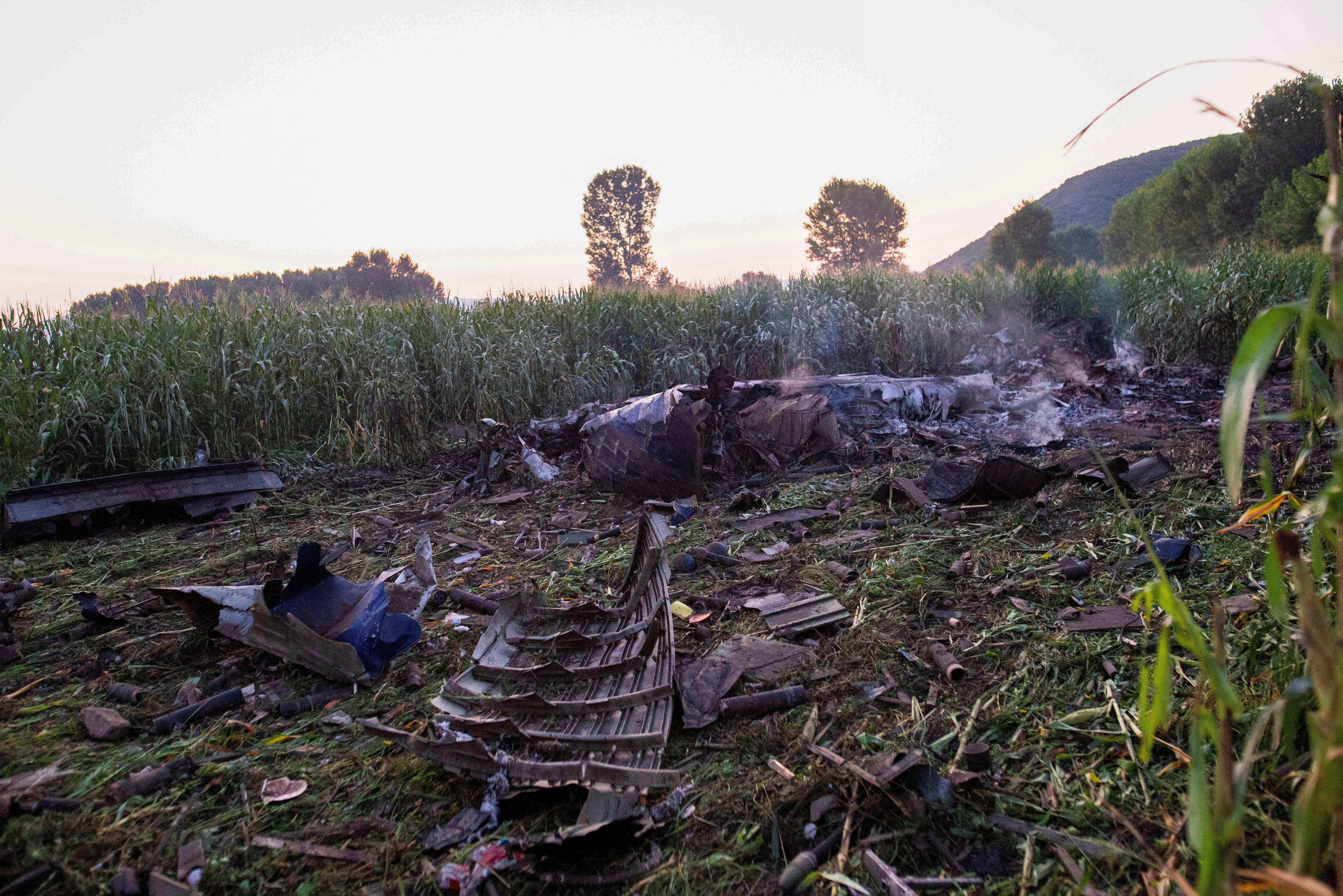Debris is seen at the crash site of an Antonov An-12 cargo plane