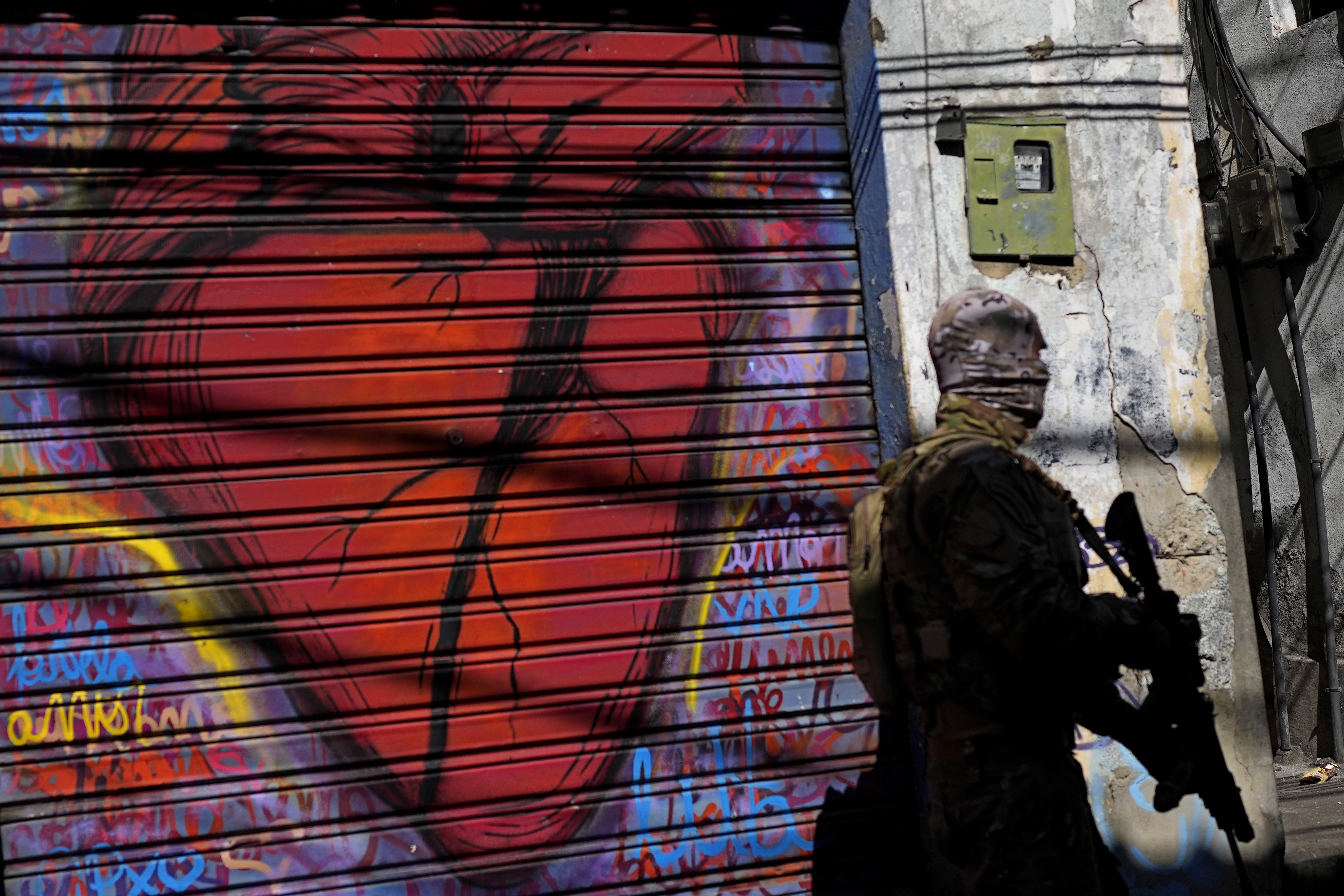 A police officer takes part in the operation in Complexo do Alemao, Rio de Janeiro, Brazil