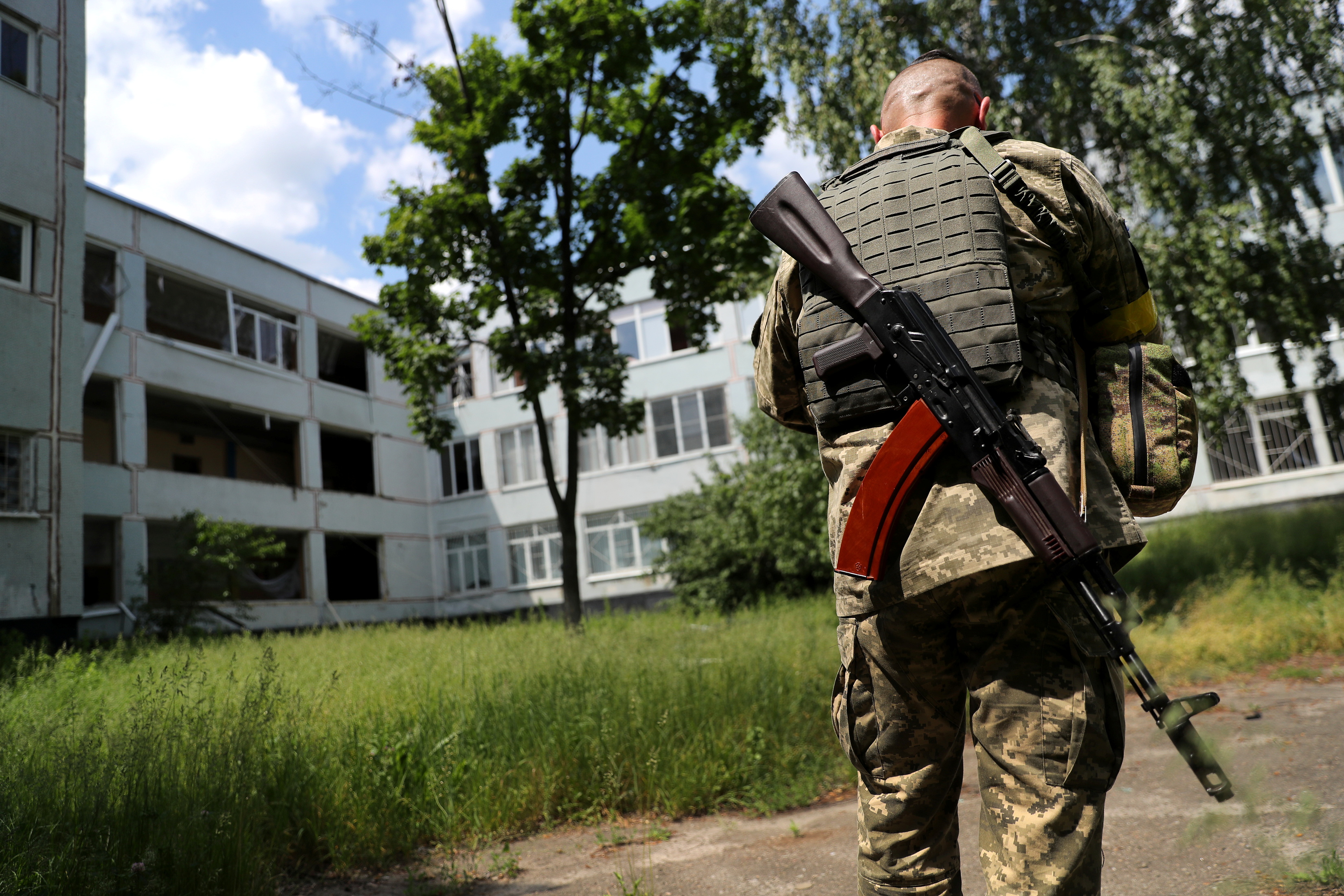 A member of the Ukrainian Territorial Defence Forces is seen preparing to use a drone at a school damaged by a Russian missile strike