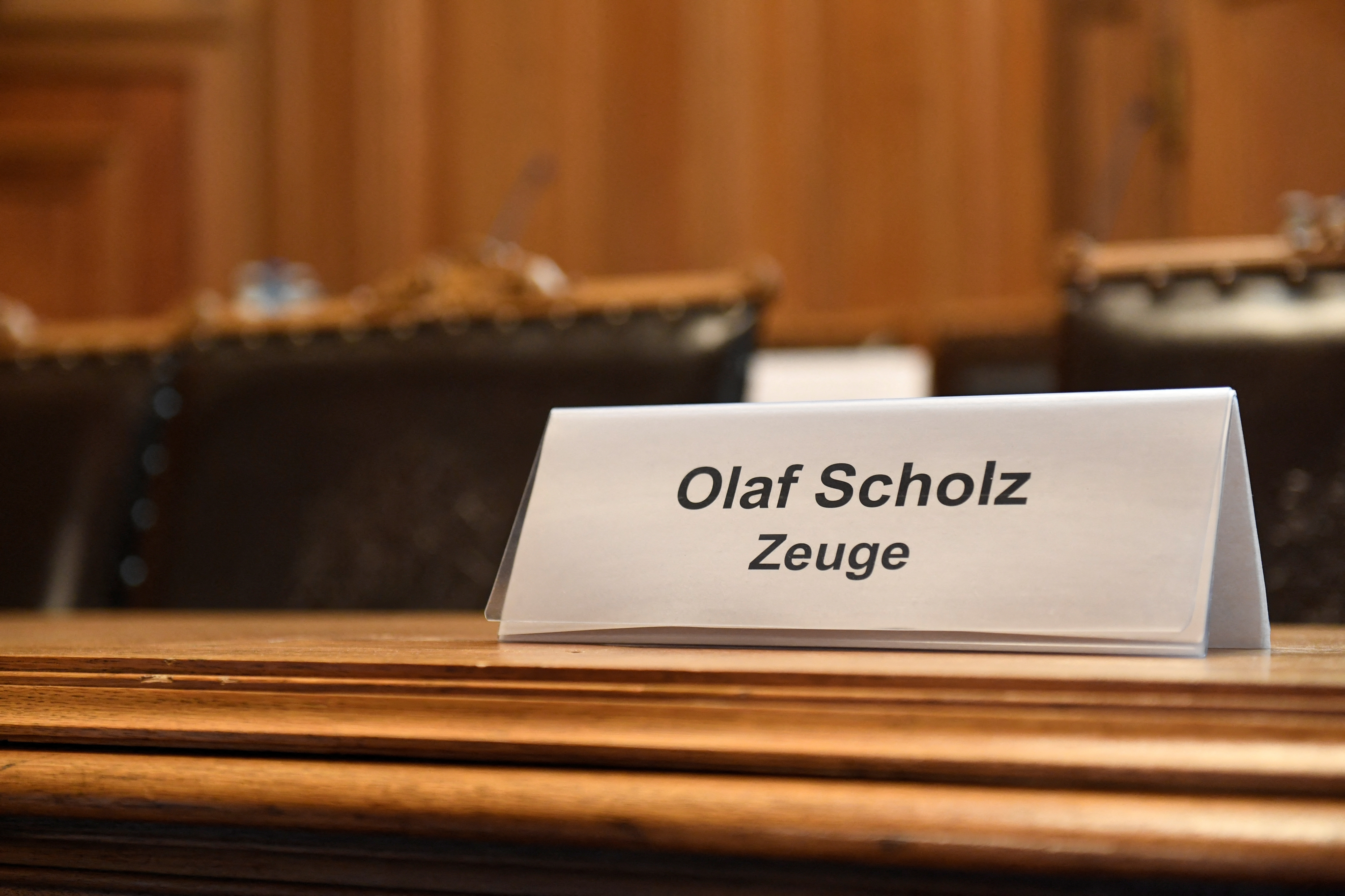 A sign reading: ‘Olaf Scholz Witness’