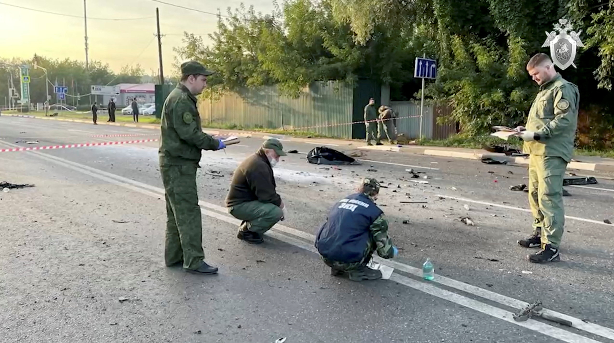 Investigators work at the site of a suspected car bomb attack that killed Darya Dugina near Moscow, Russia.